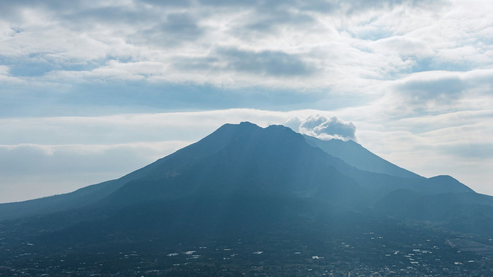 white clouds over snow covered mountain