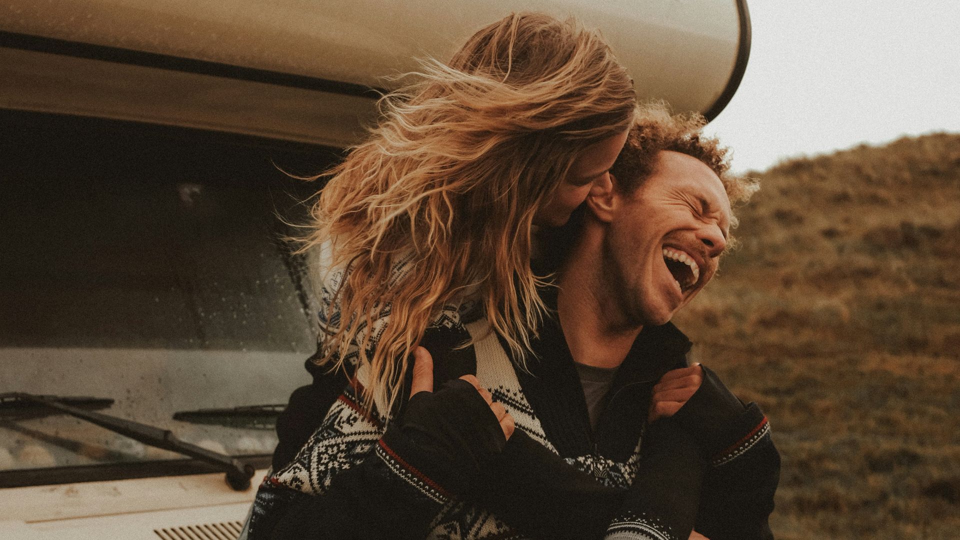 a man and a woman standing in front of a truck
