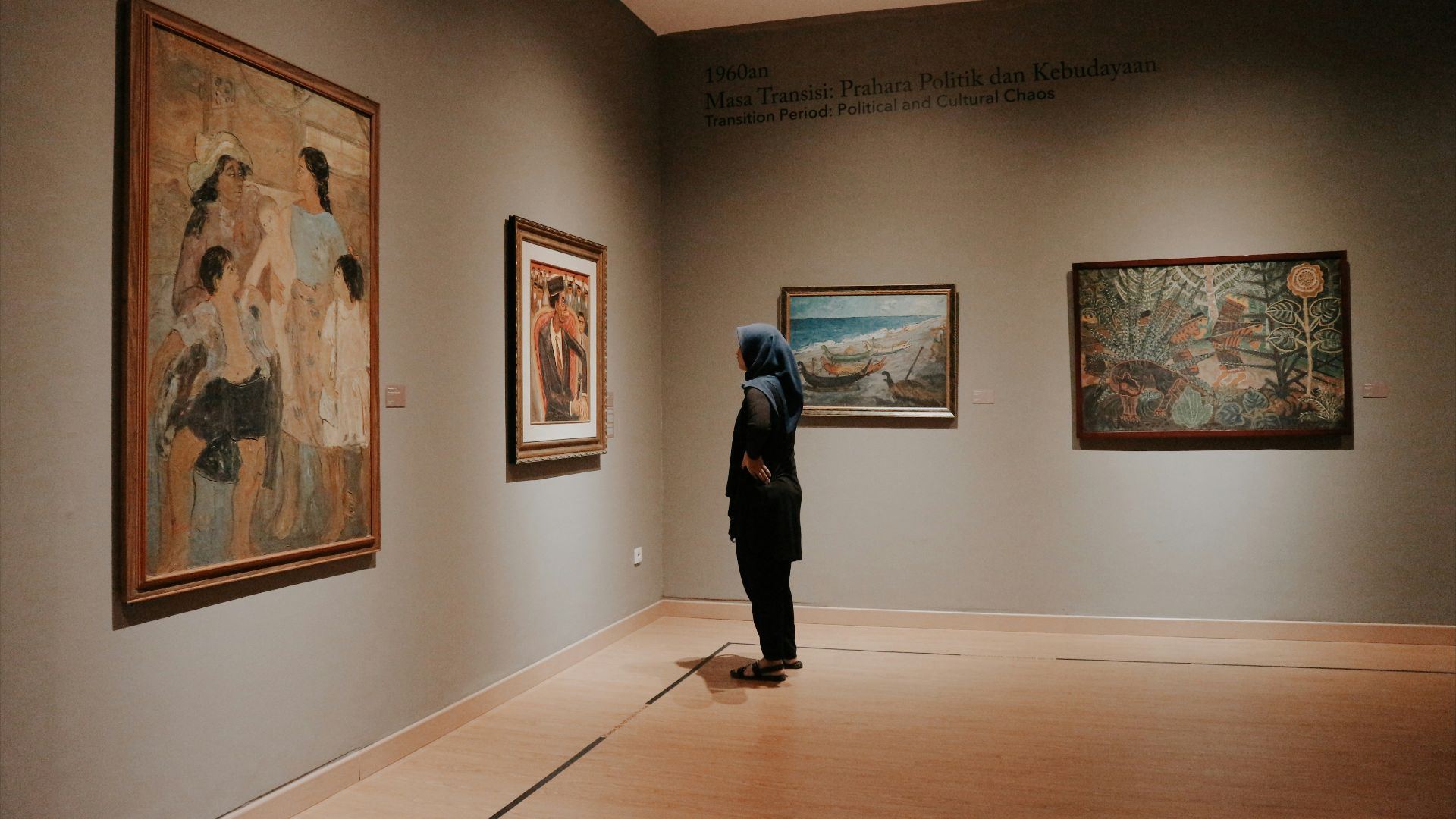 woman standing in front of paintings