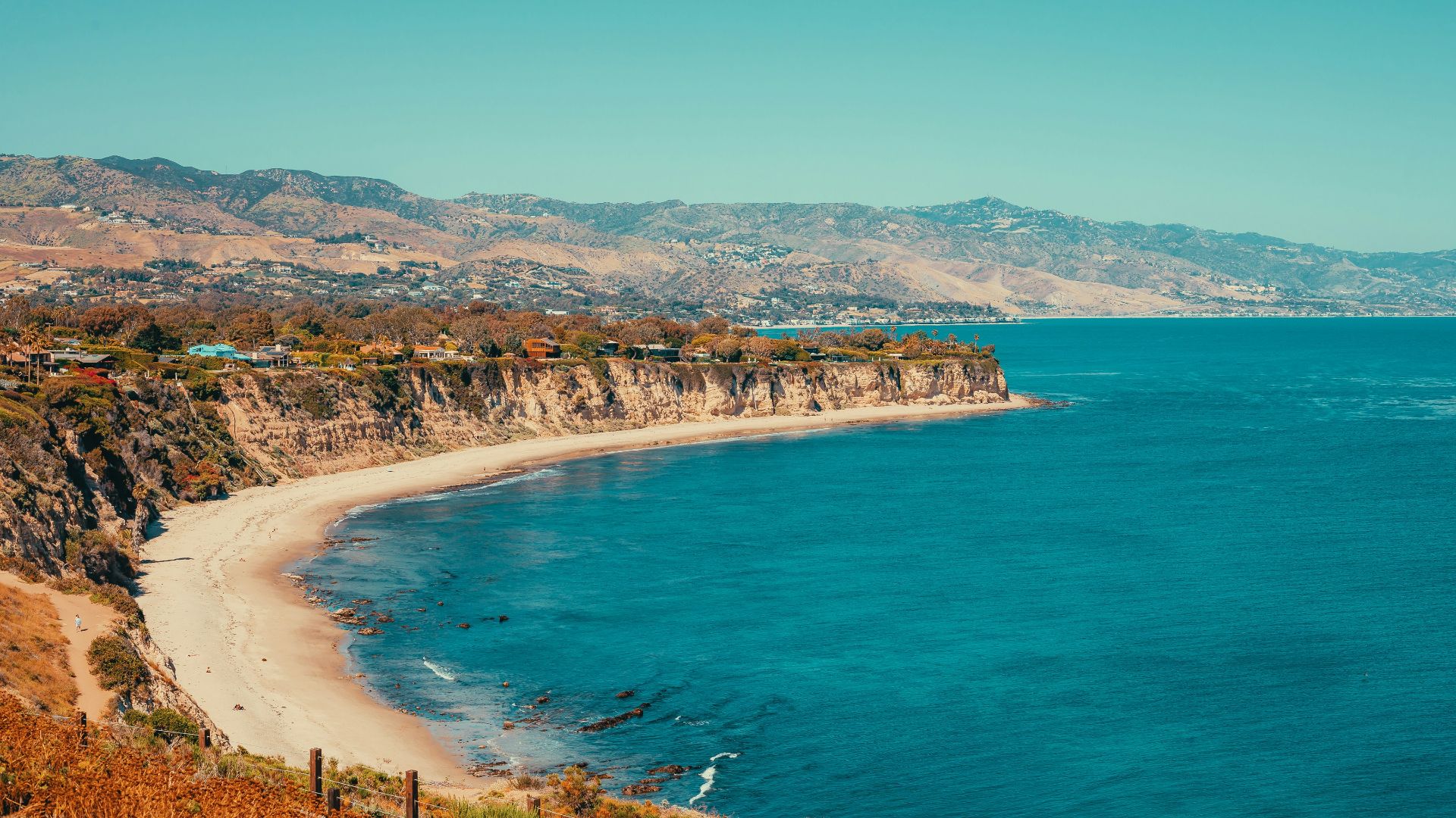 a view of a beach with a mountain in the background