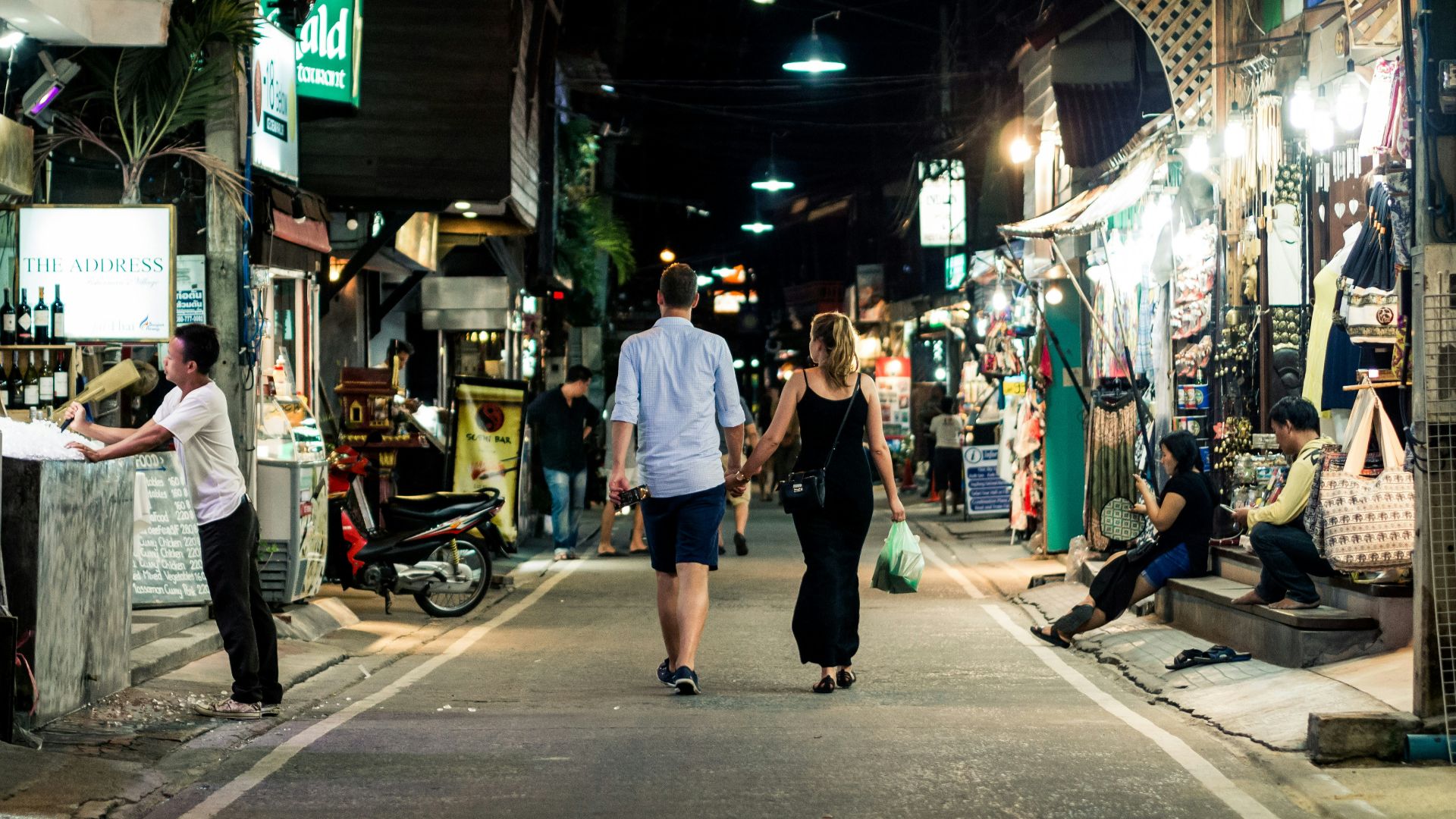 man and woman walking on street