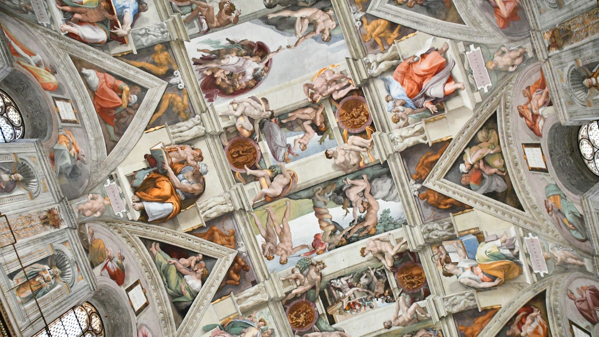 the ceiling of a building with many paintings on it