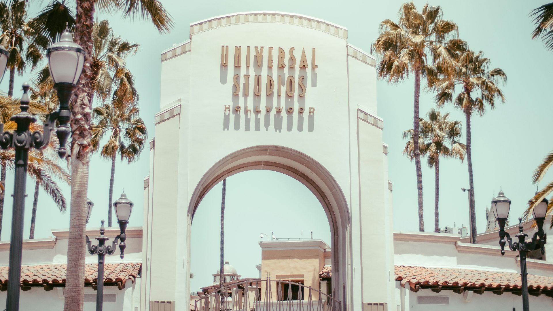 white concrete building near palm trees during daytime