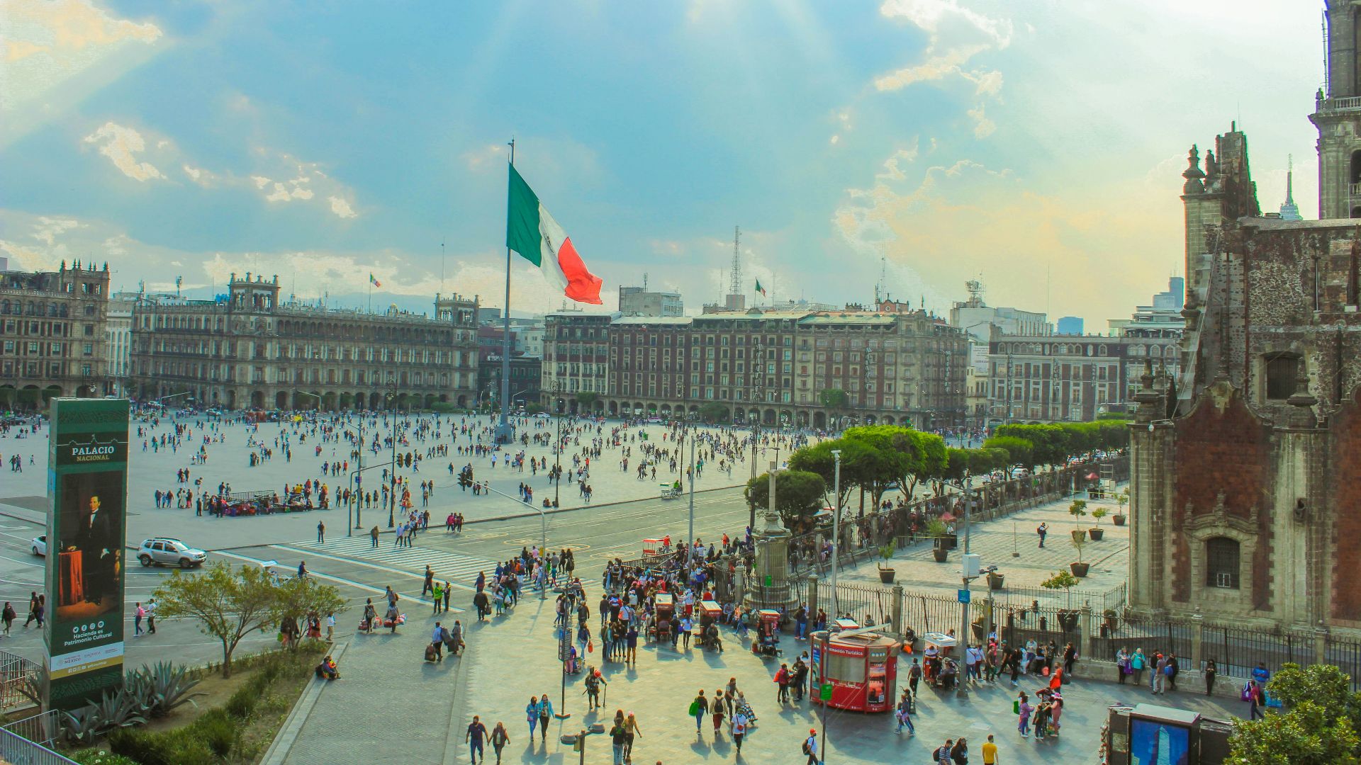 a large group of people walking around a city