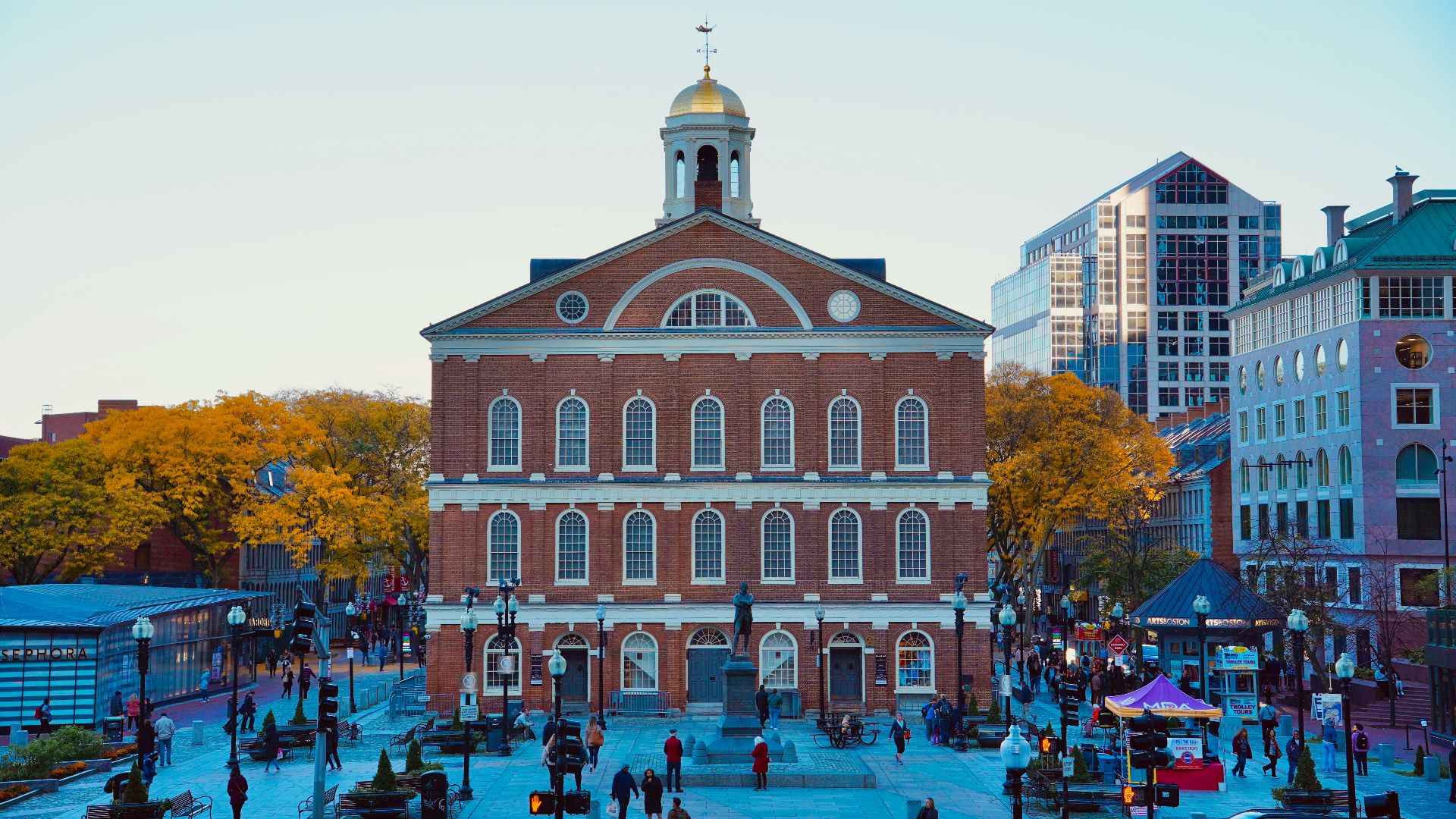 a large brick building with a dome with Faneuil Hall in the background