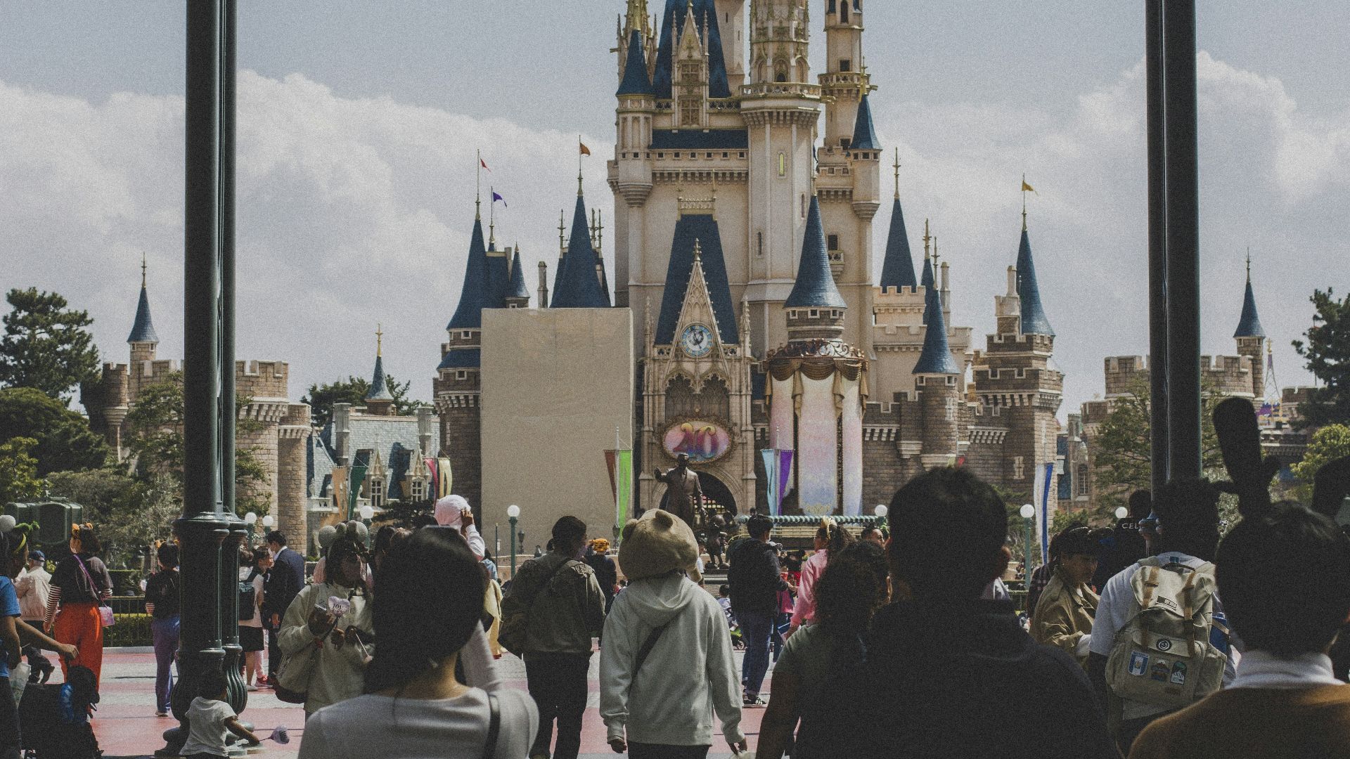 a group of people walking in front of a castle