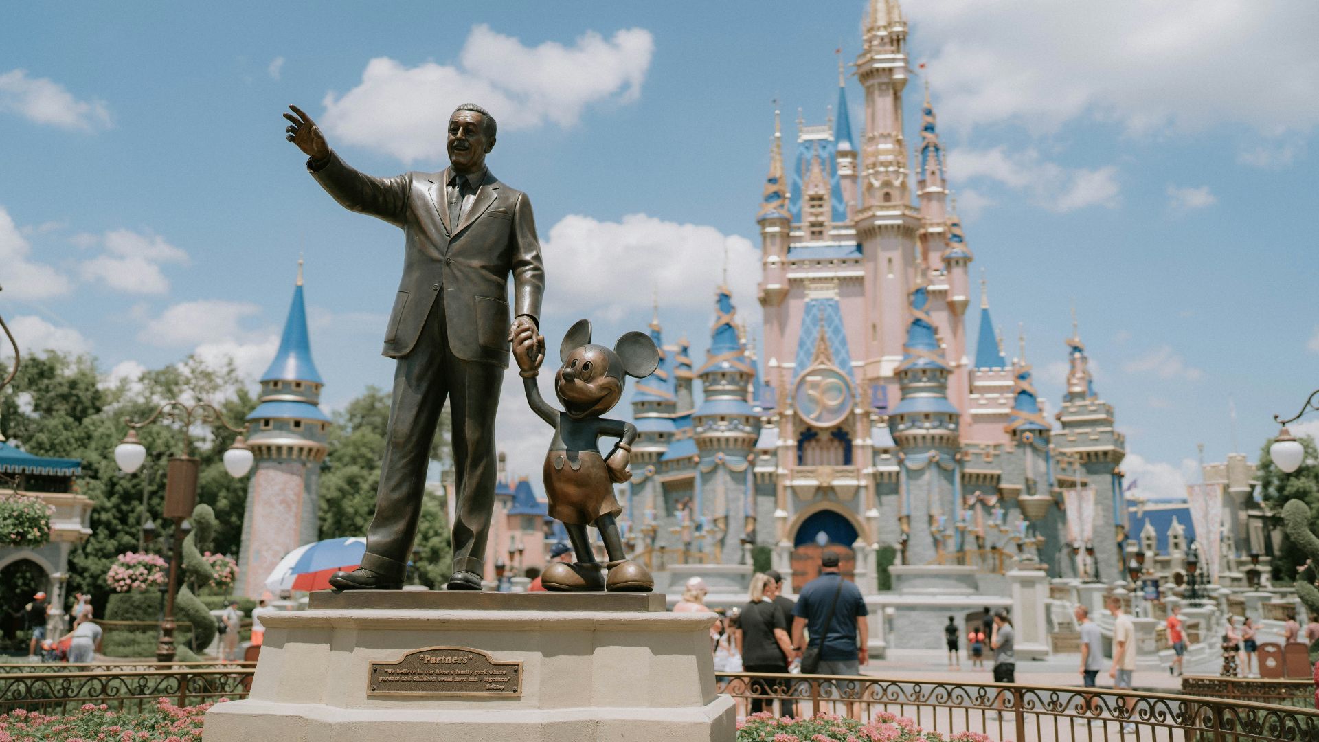 a statue of a man in front of a castle