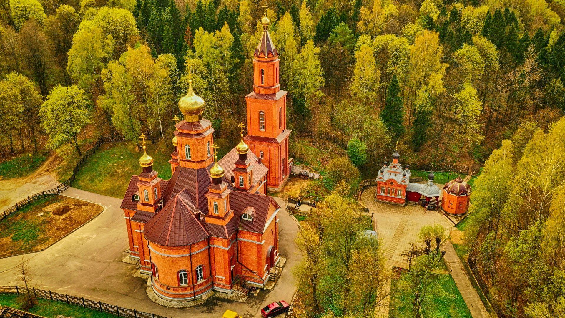 a red building surrounded by trees