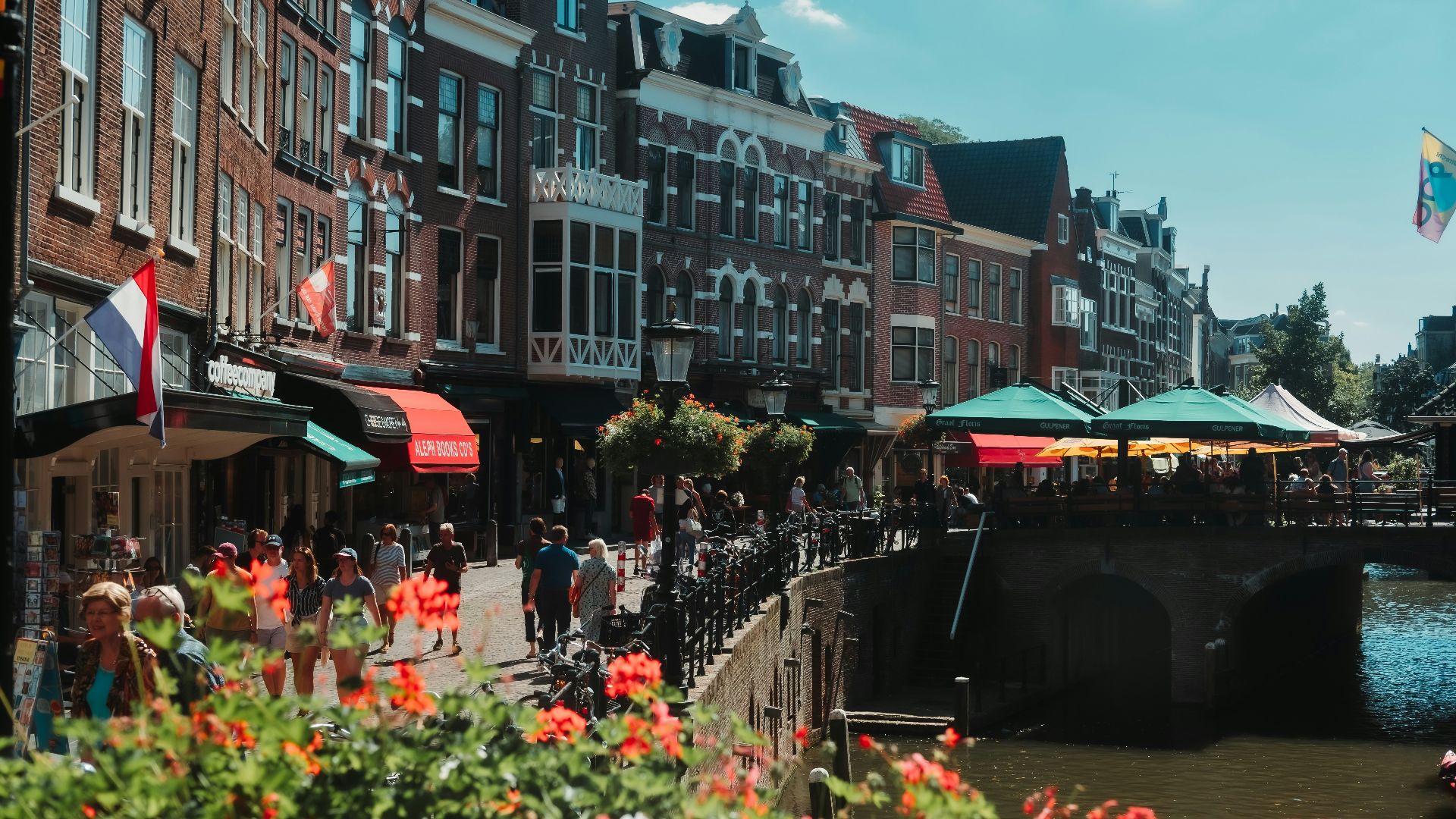 a group of people walking on a bridge over a river