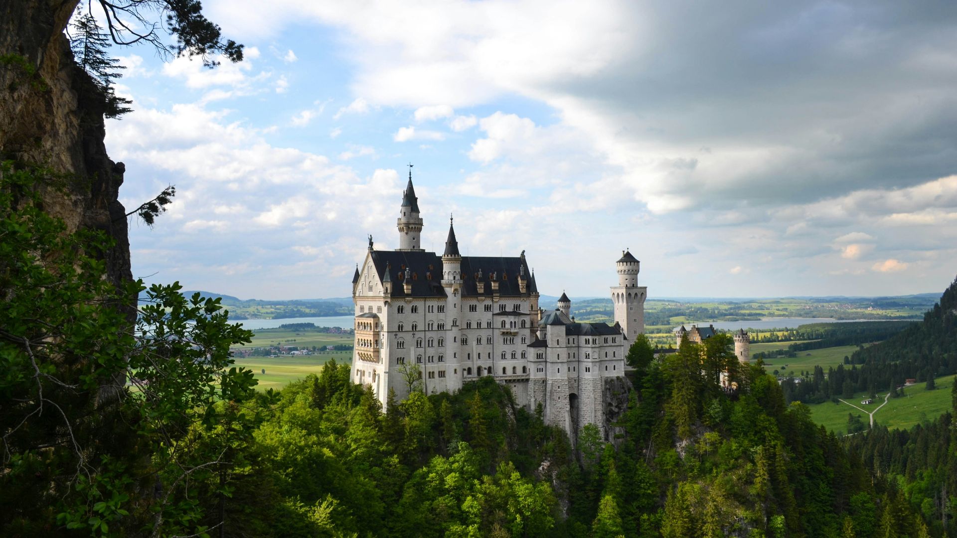 white castle surround by green trees during daytime