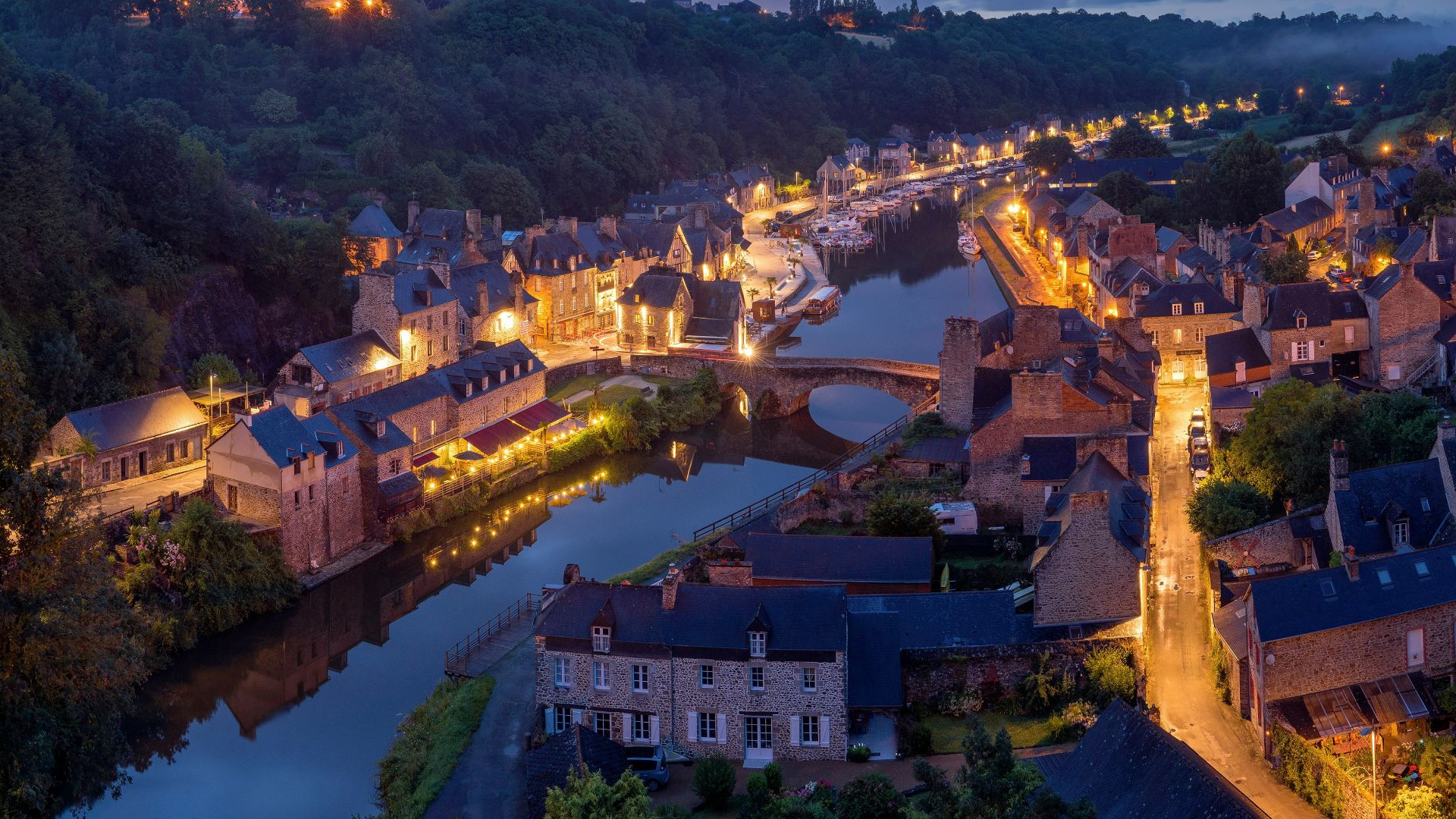 aerial photography of lighted concrete buildings at night time