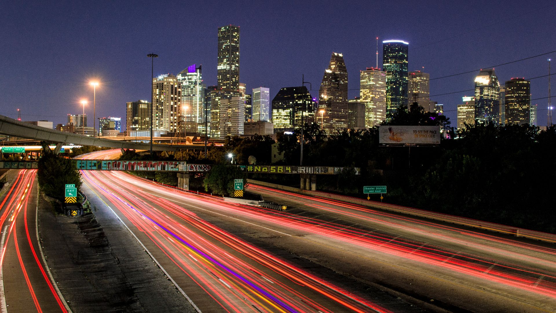 time lapse photography of vehicle traveling with a speed of light in road