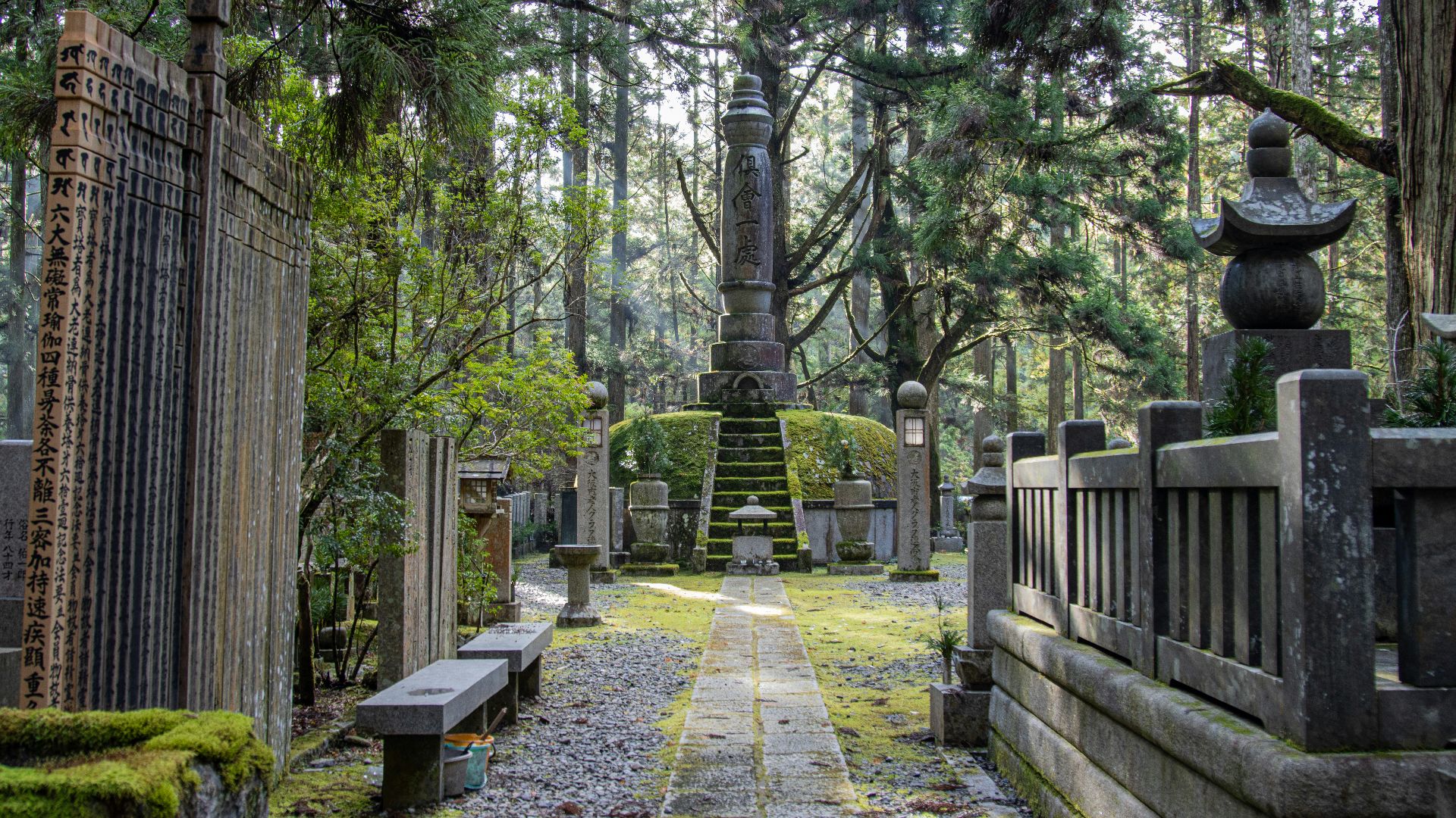 a cemetery with a tall tower in the middle of it