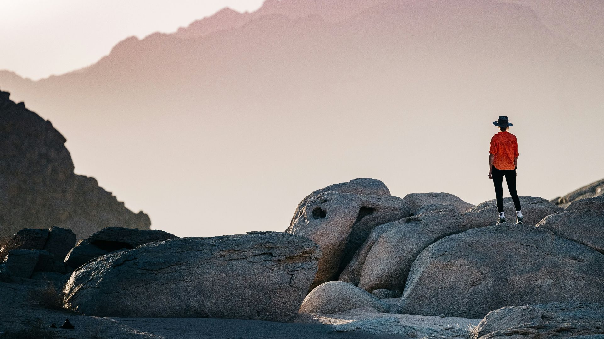 a person standing on top of a large rock