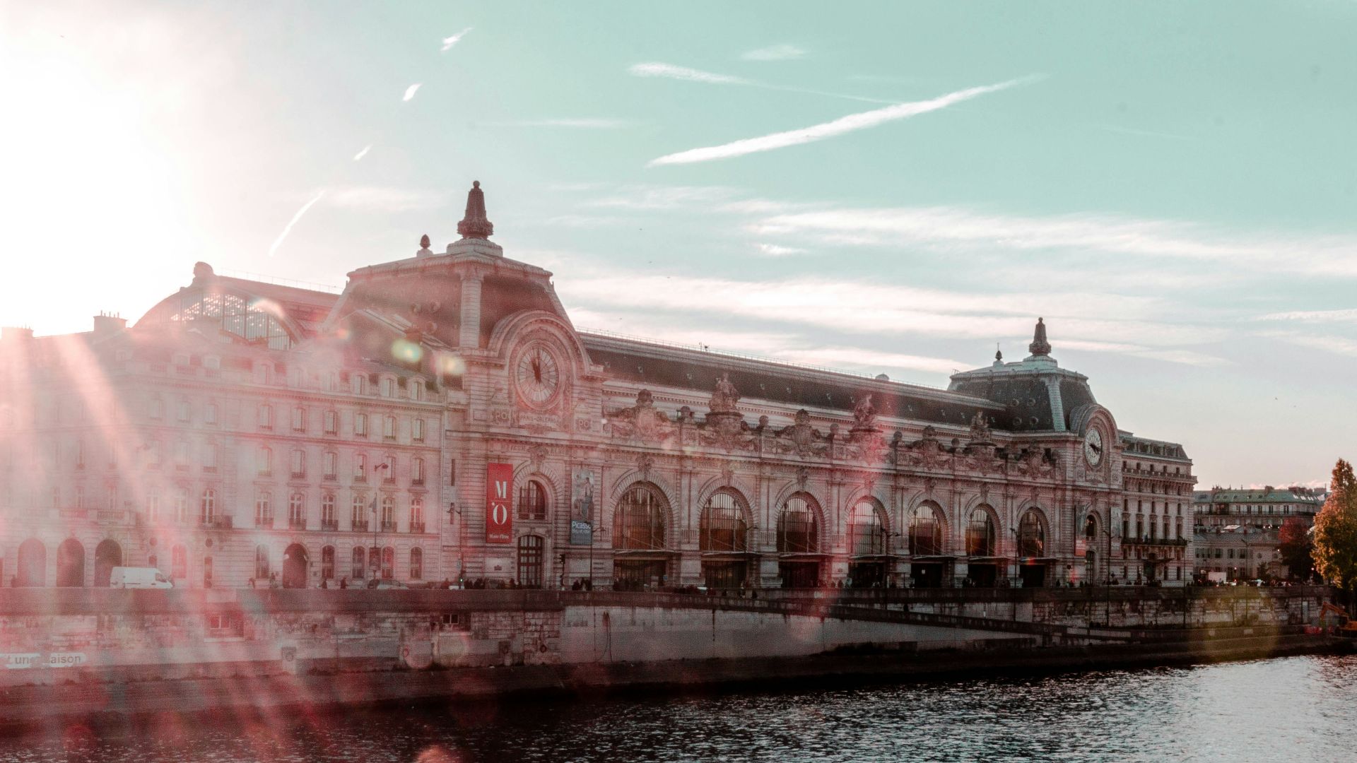 gray and black building beside body of water during daytime