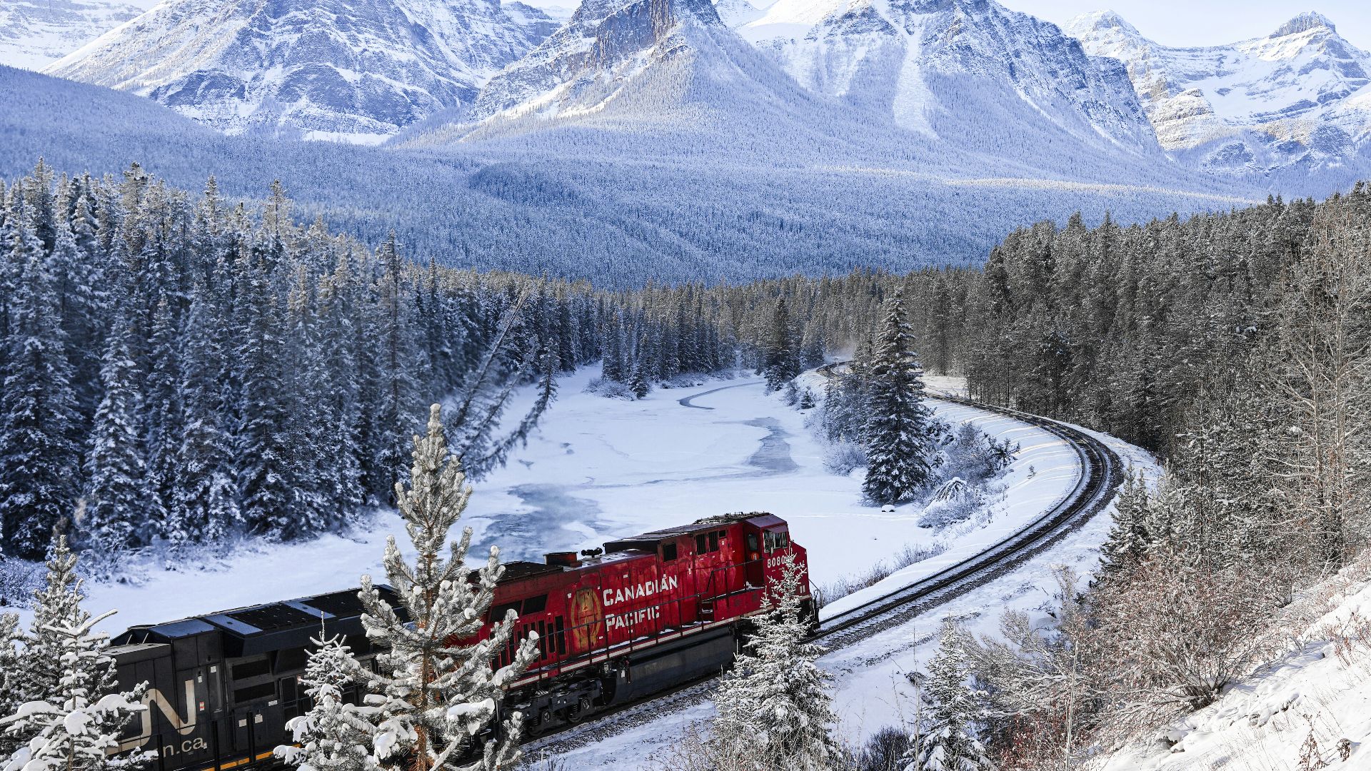 a train traveling through a snow covered forest