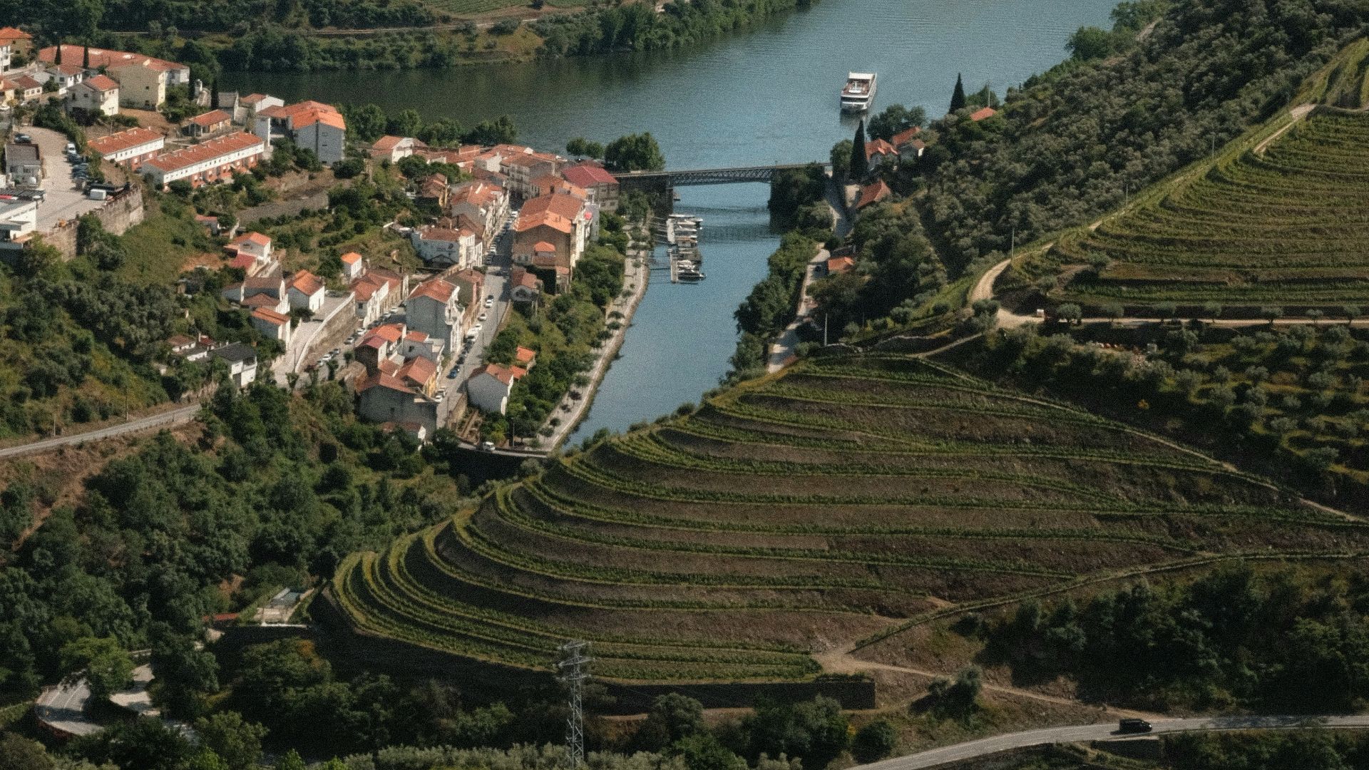 a river running through a lush green hillside