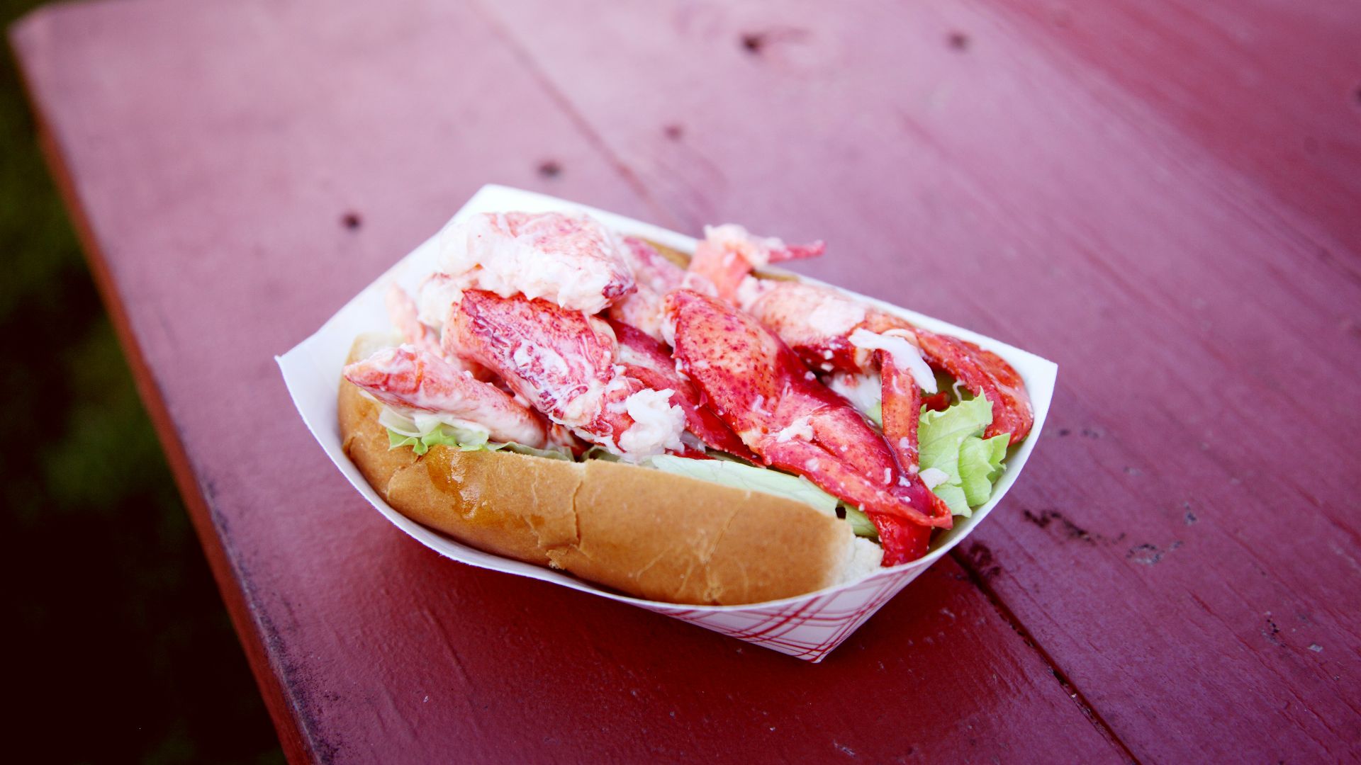 person holding bread with ham and cheese
