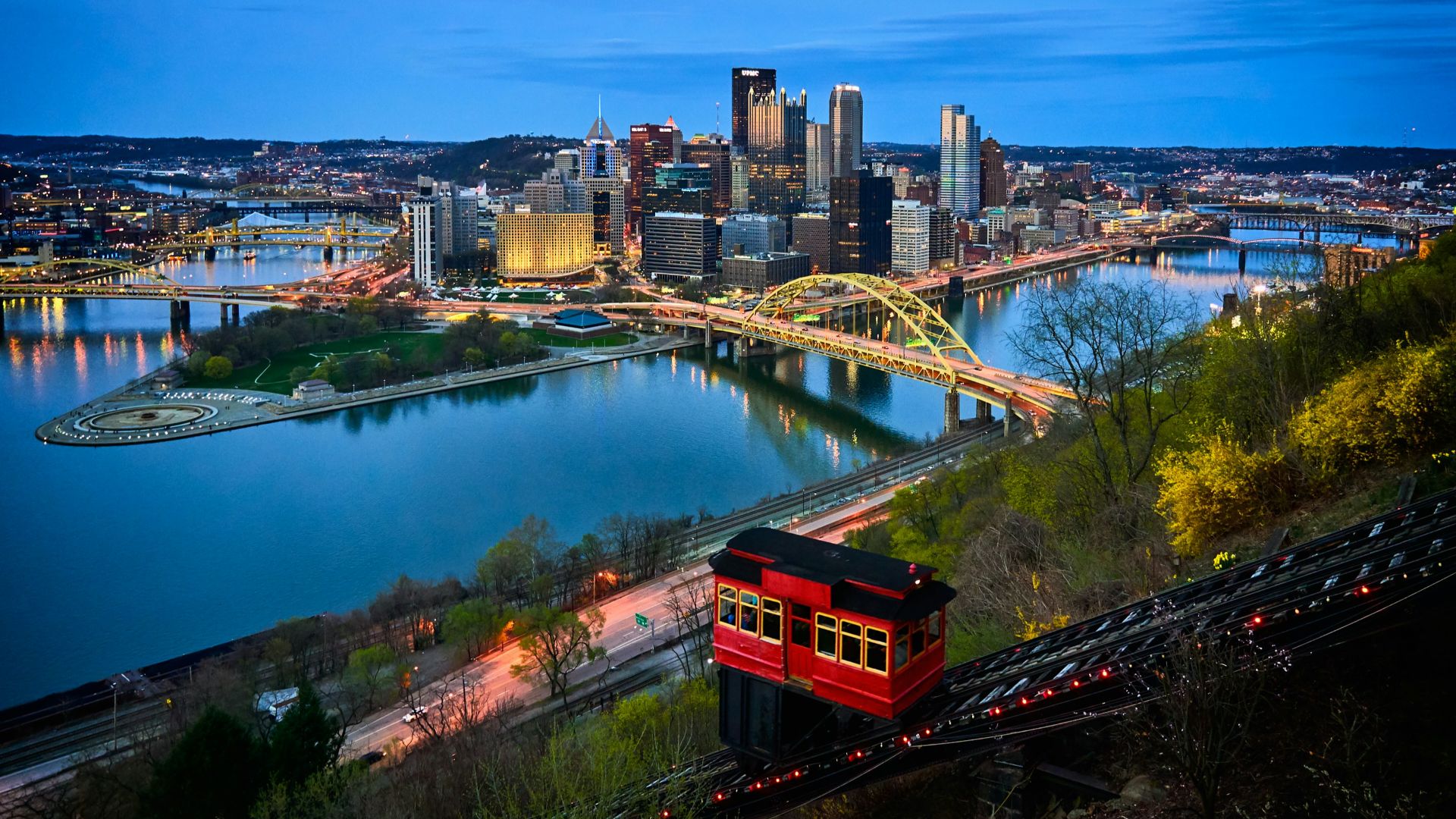 aerial photo of bridge and buildings under blue sky