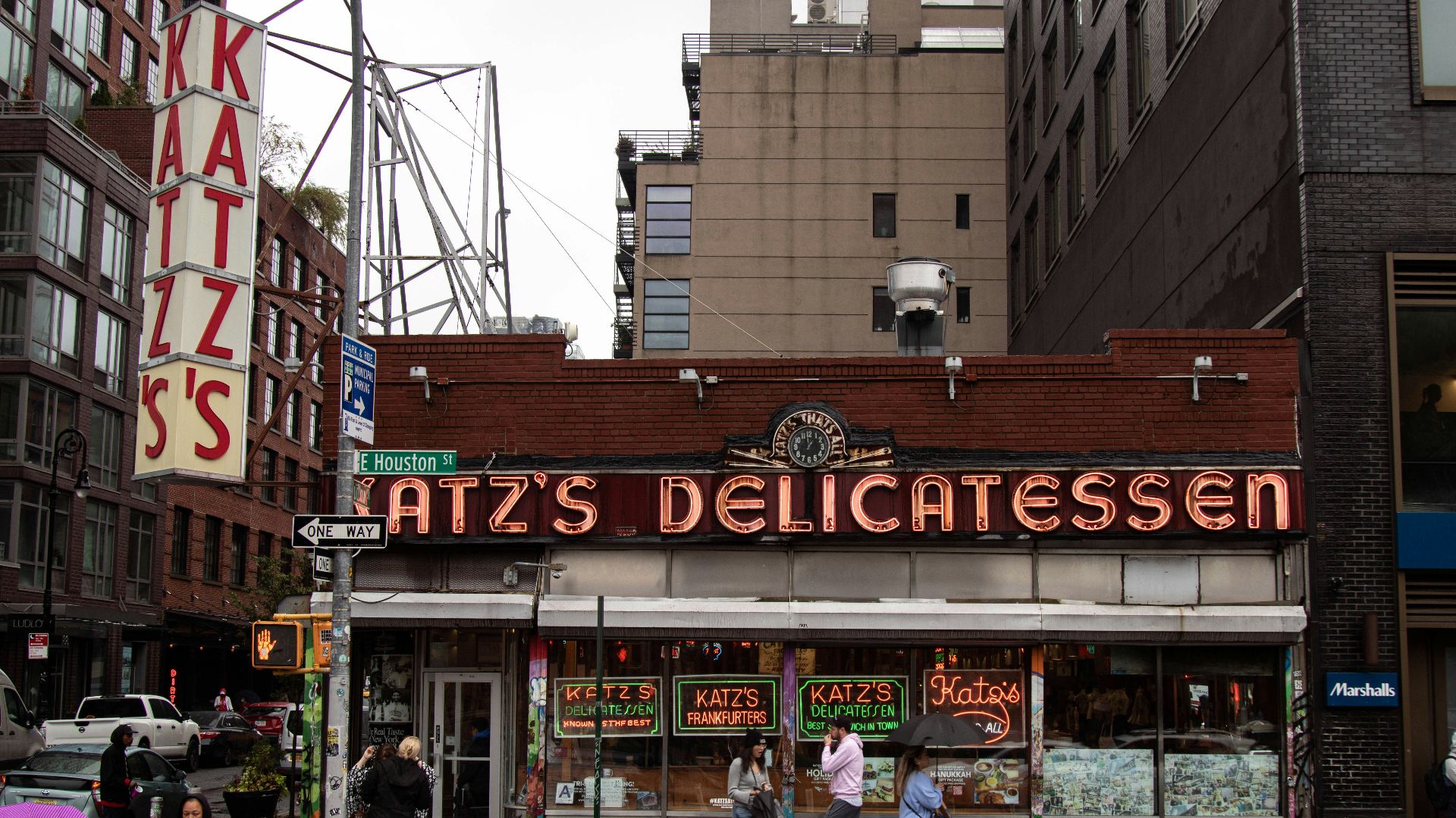 a group of people standing outside of a restaurant