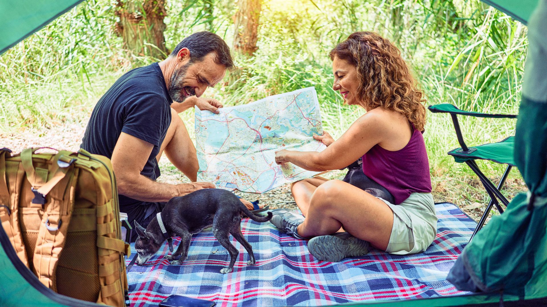 man in blue crew neck t-shirt and brown shorts sitting on blue and white textile