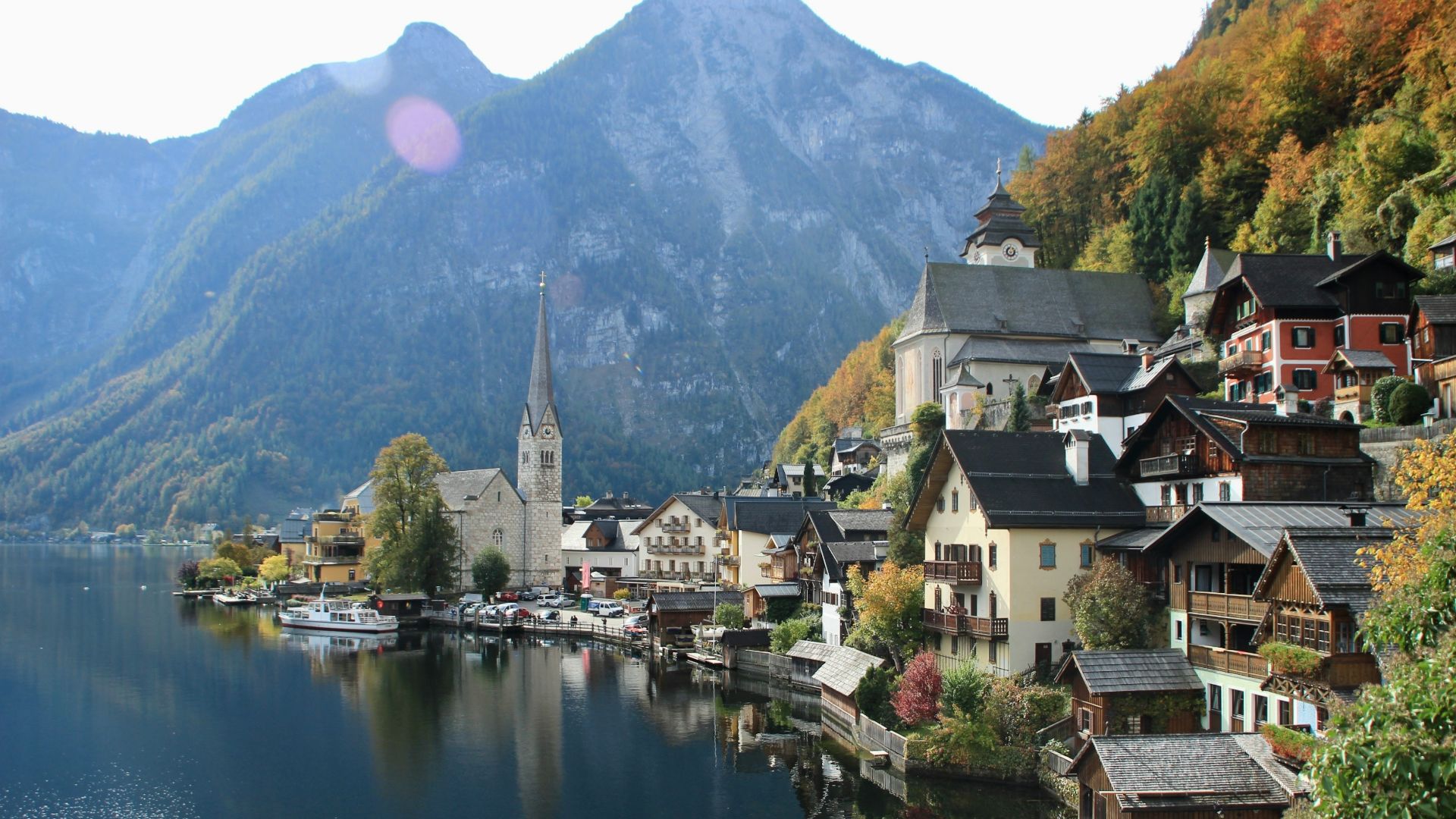a lake surrounded by mountains and houses