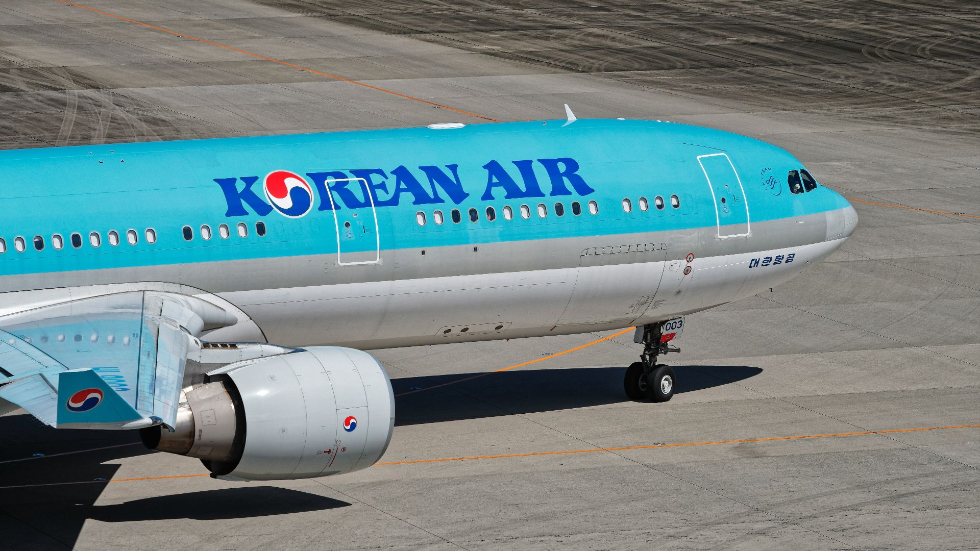A korean air plane is on the runway