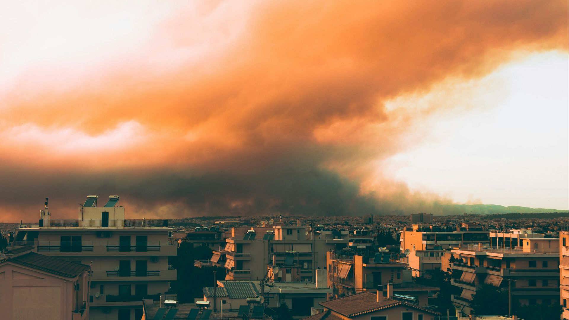 city with high rise buildings under white clouds during daytime