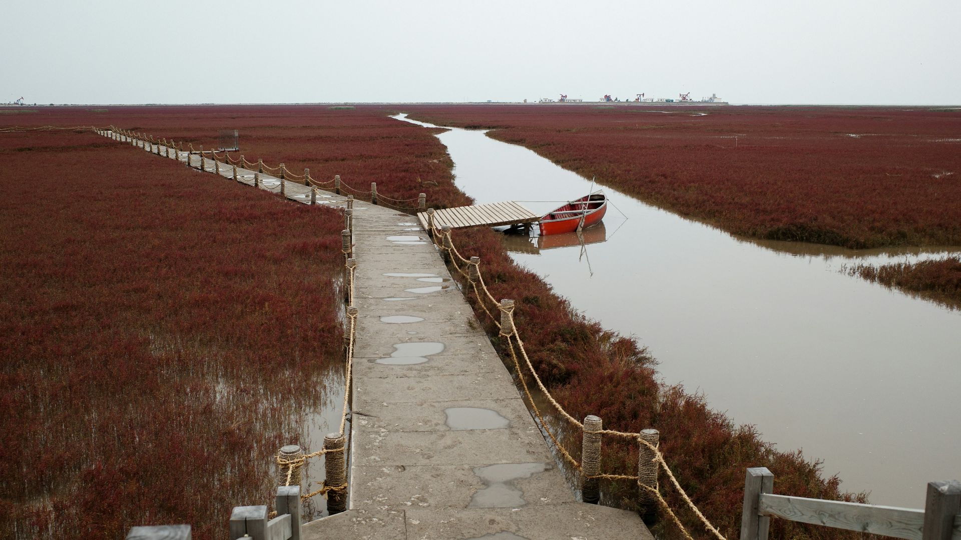 a path leading to a boat tied to a dock