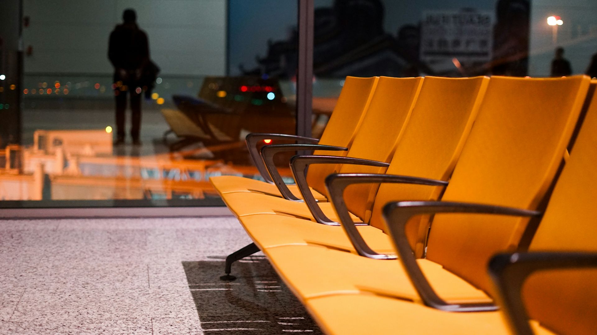 a row of yellow chairs sitting on top of a floor