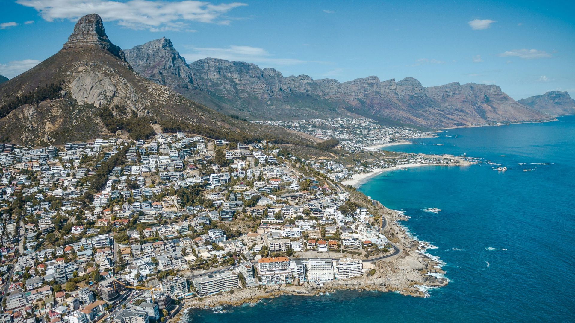 city beside body of water and mountains