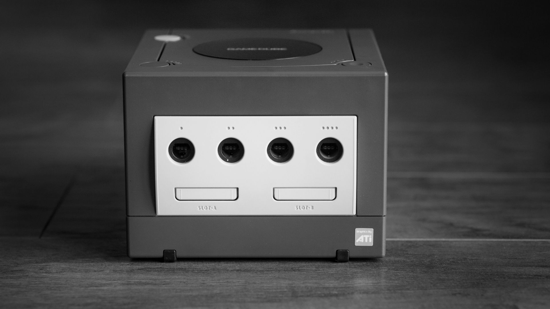 white and black Nintendo GameCube on gray surface