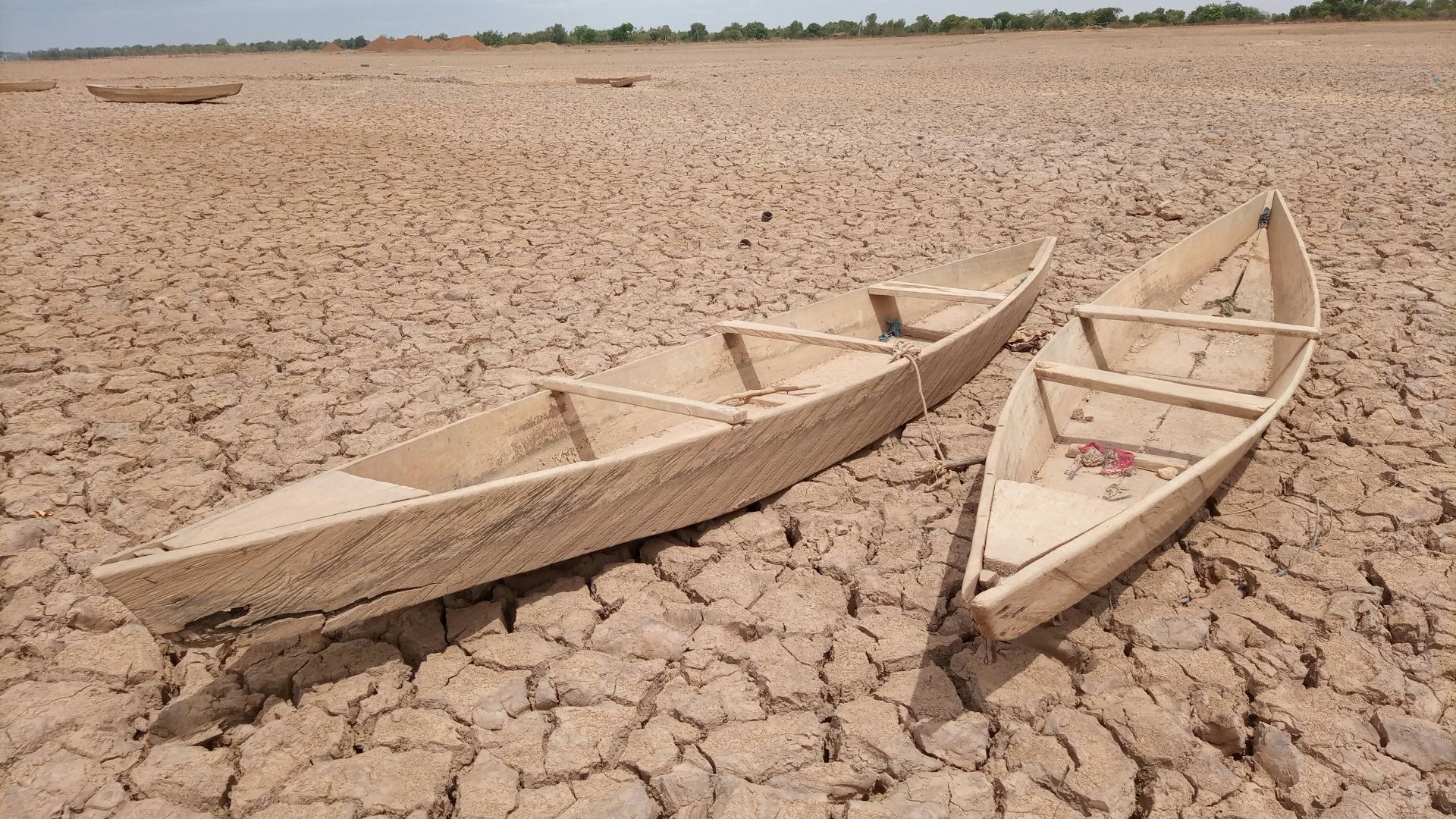 brown wooden boat on brown sand during daytime