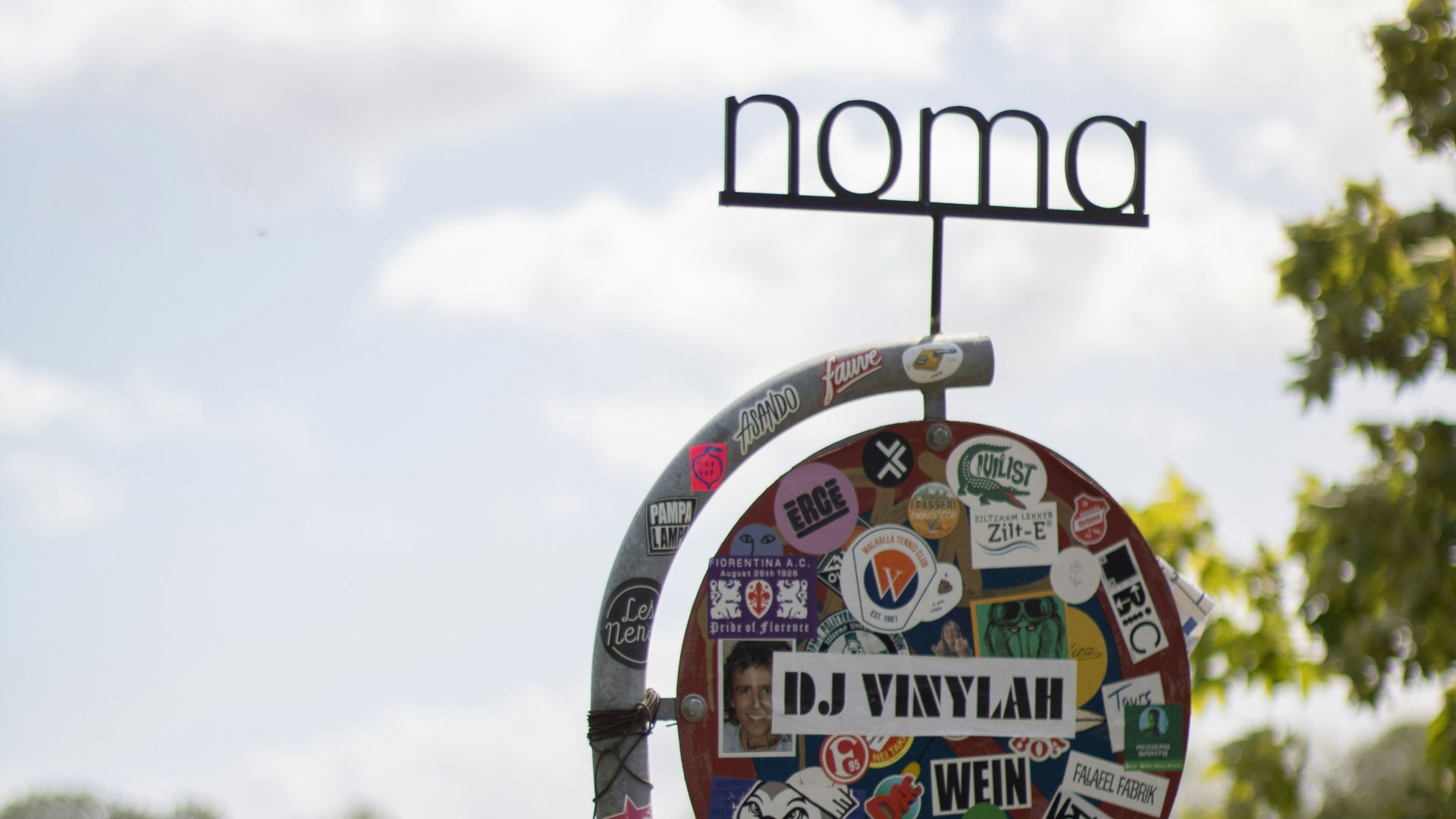 A sign with a lot of stickers on it