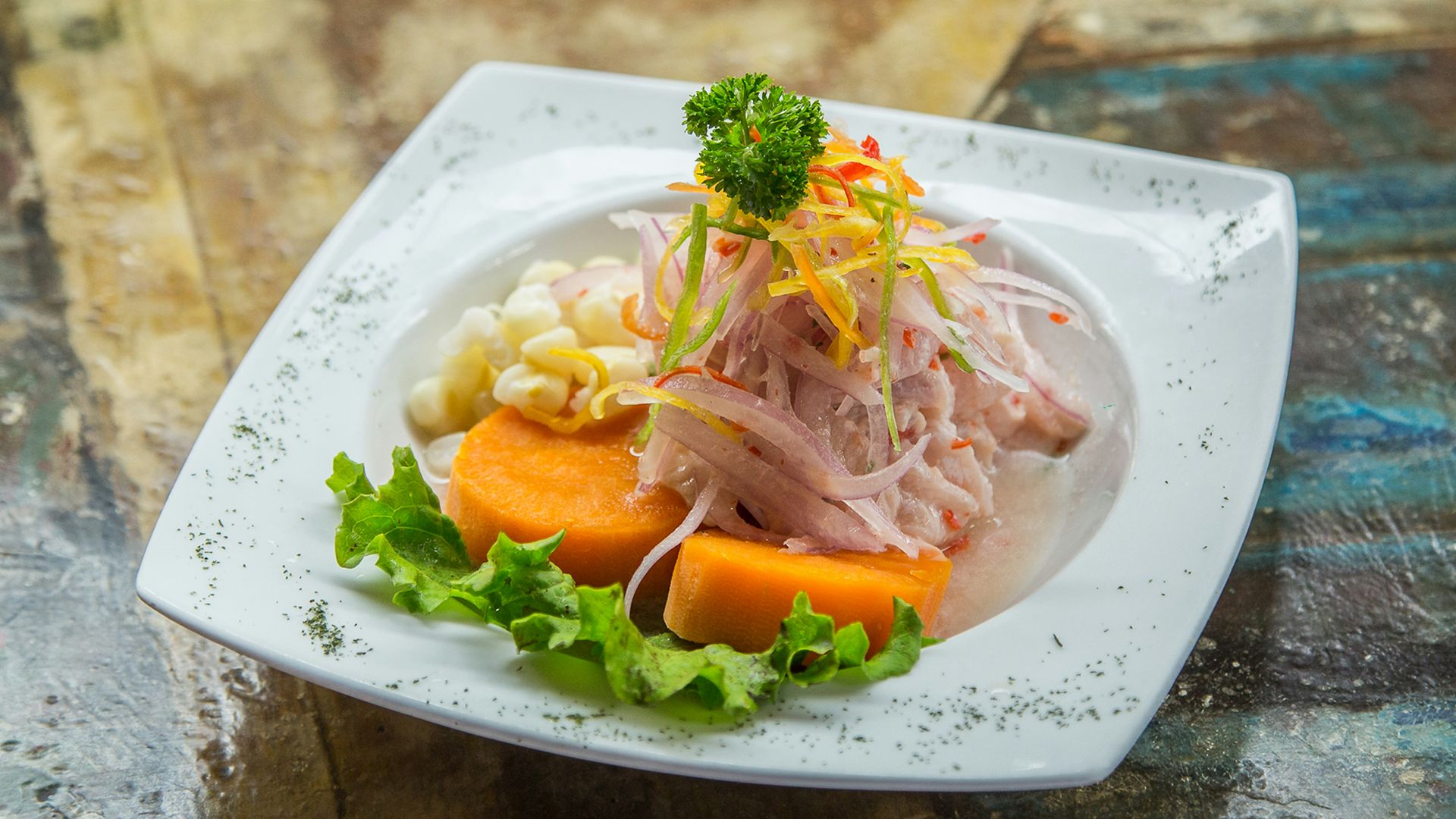 vegetable salad on white plate on brown table