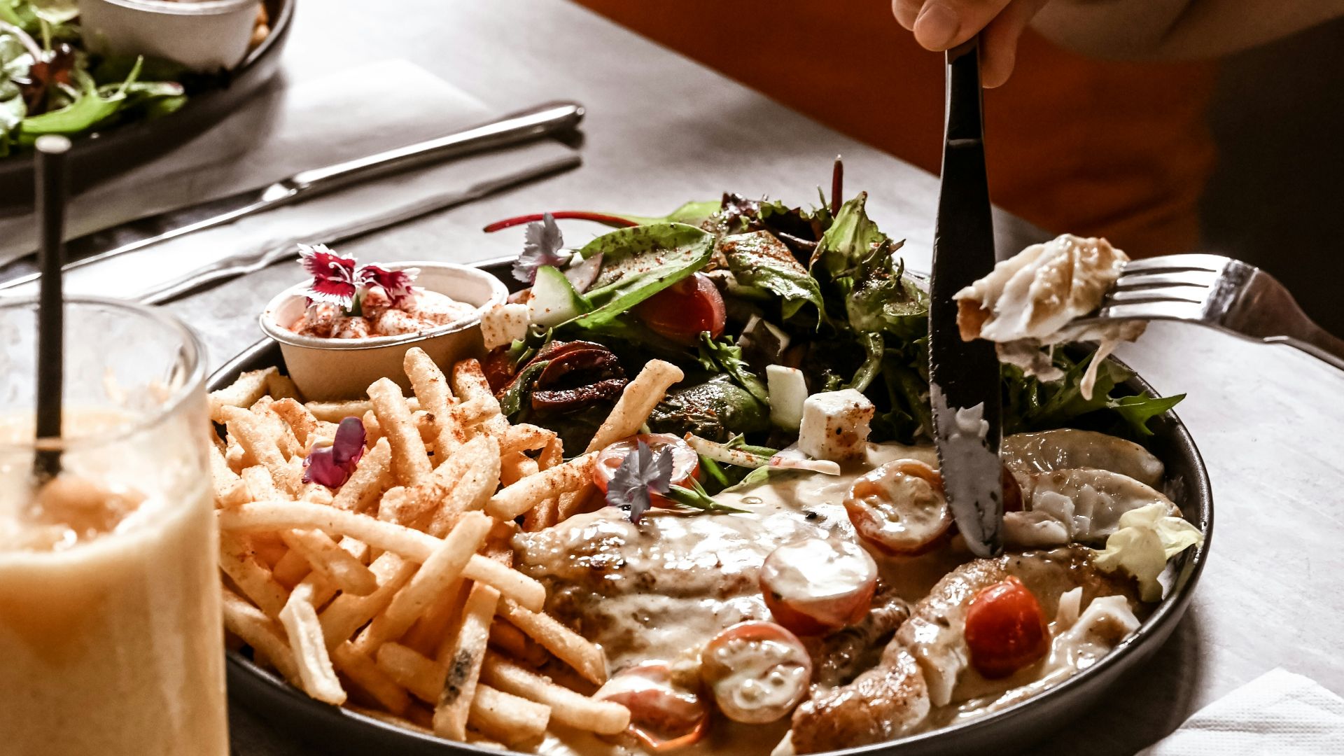 a man is cutting into a plate of food