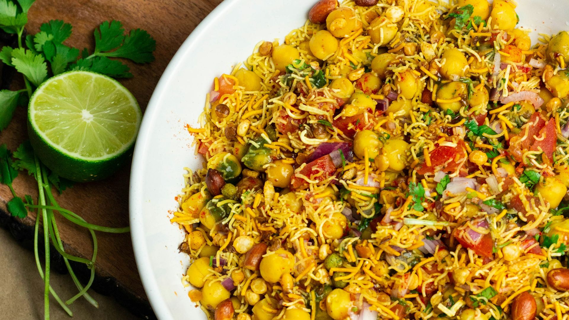 a white bowl filled with food on top of a wooden cutting board