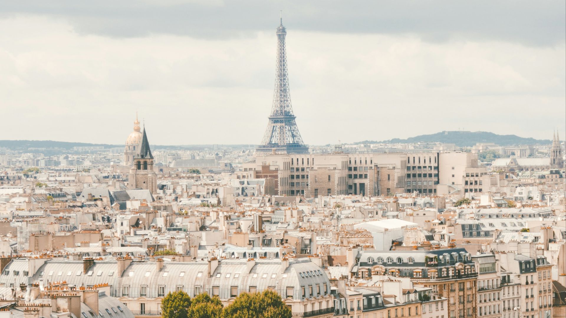 group of people walking near body of water and building under blue sky at daytime