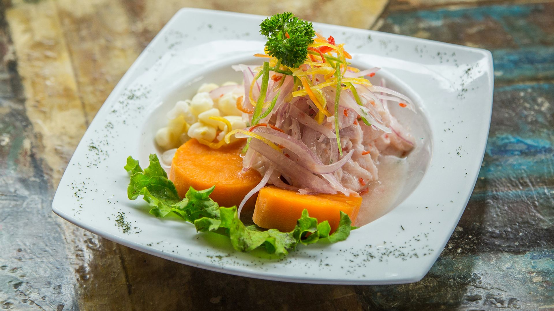 vegetable salad on white plate on brown table