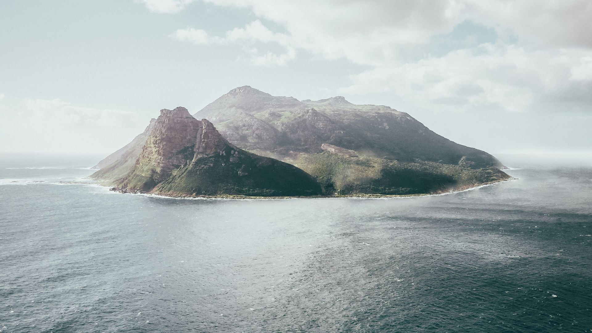 bird's eye view photography of island under white clouds