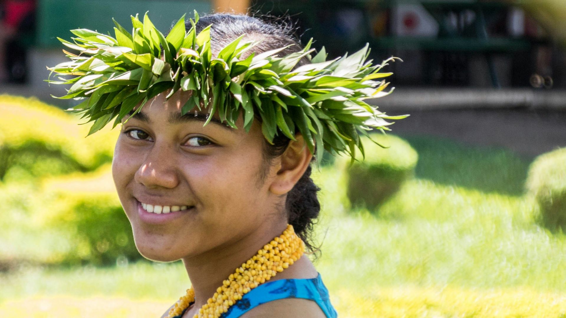 smiling woman standing in green field