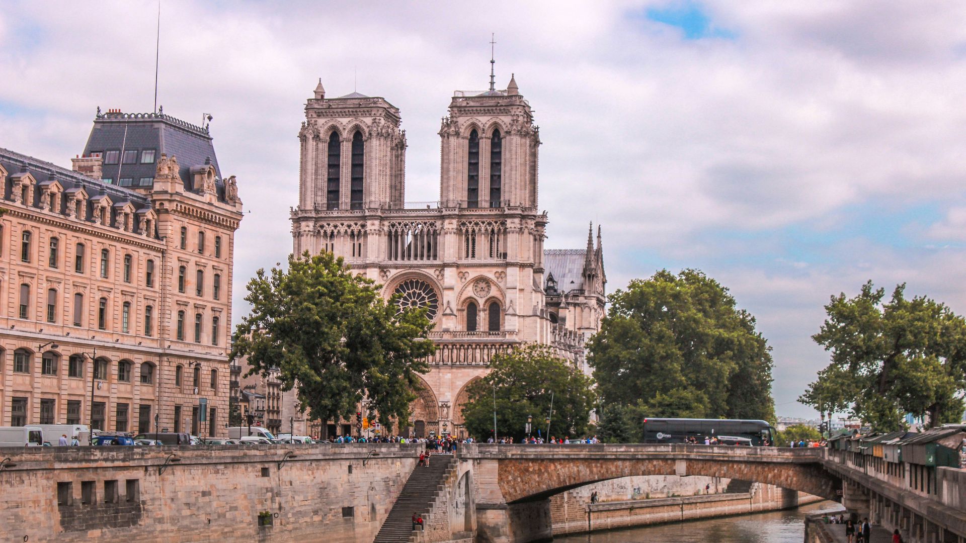 gray concrete building near green trees during daytime
