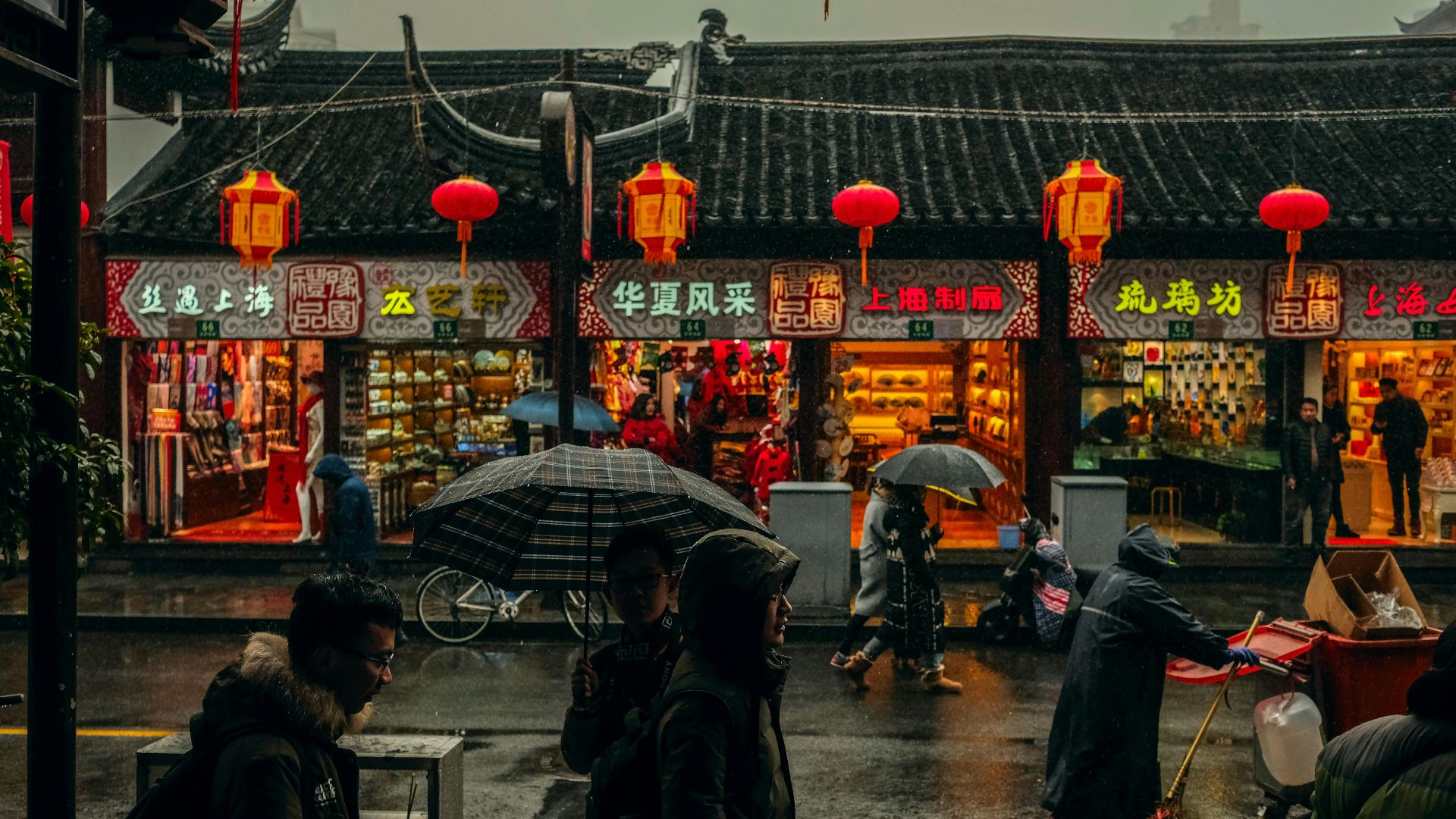 person carrying umbrellas