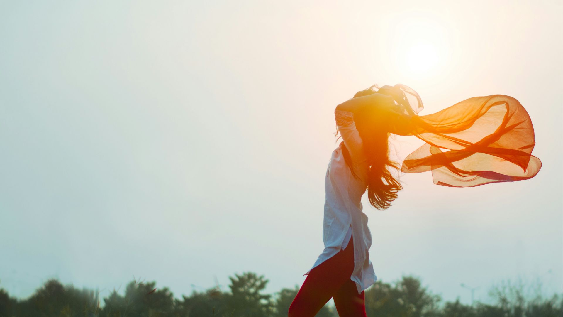 woman spreading hair at during sunset