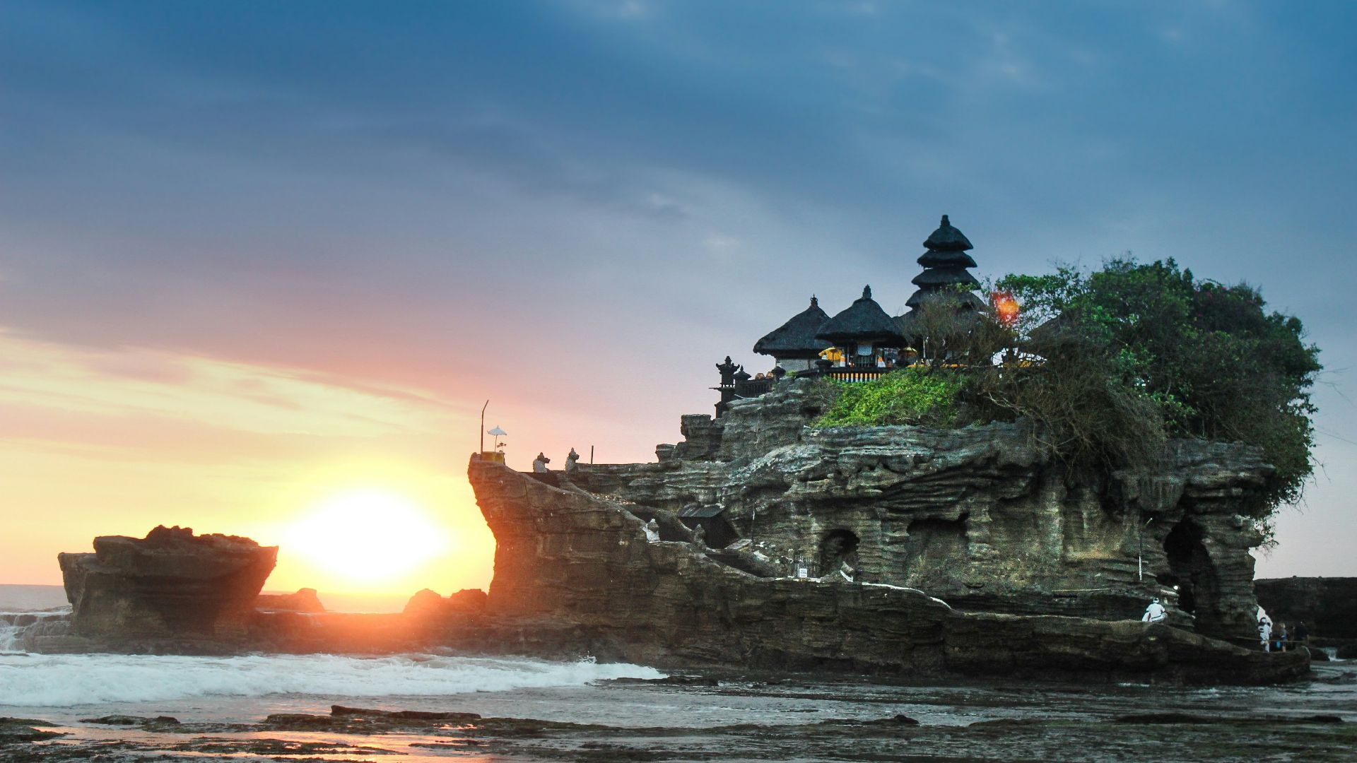 black building on gray rock hill
