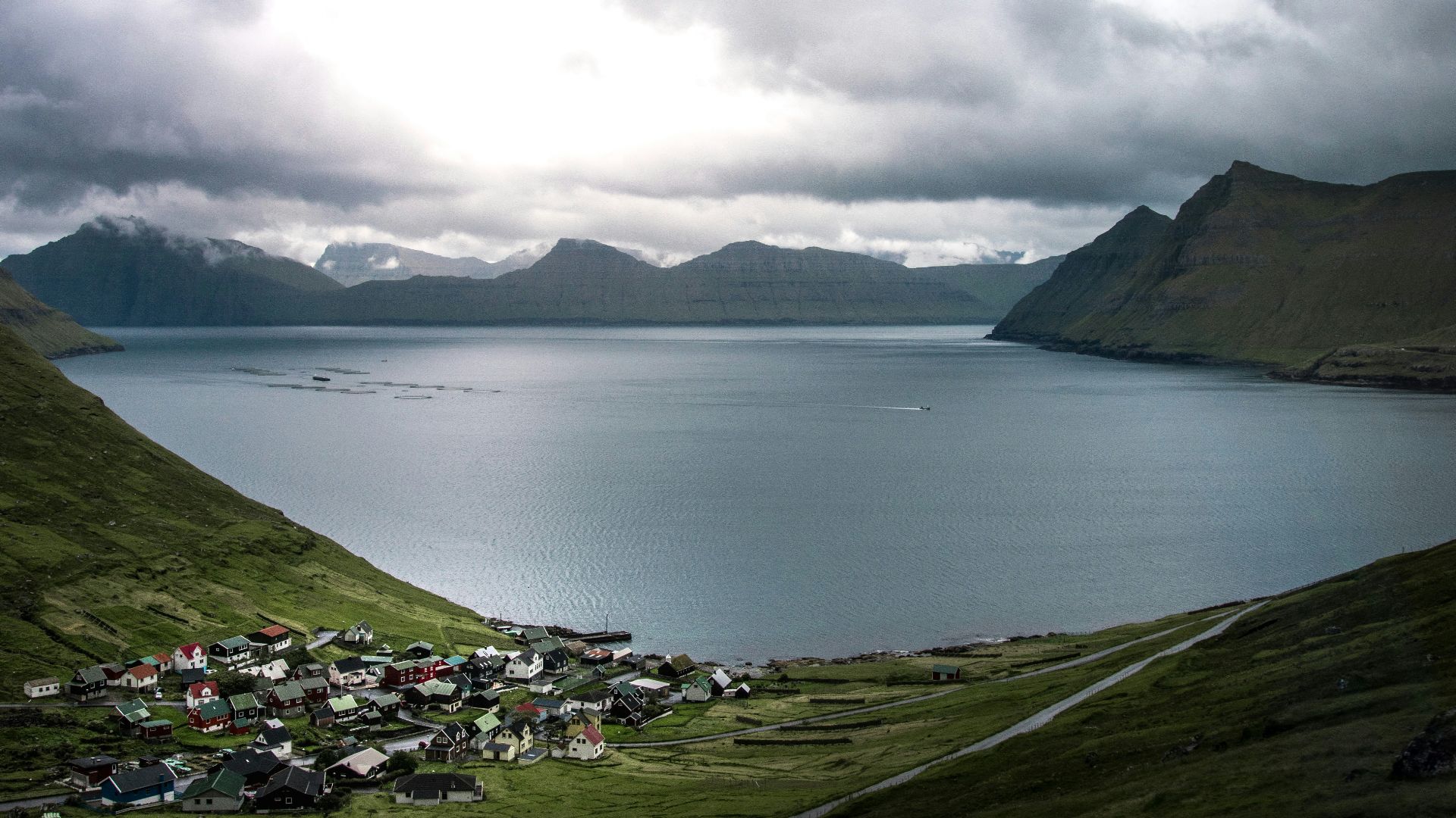 calm body of water and mountain