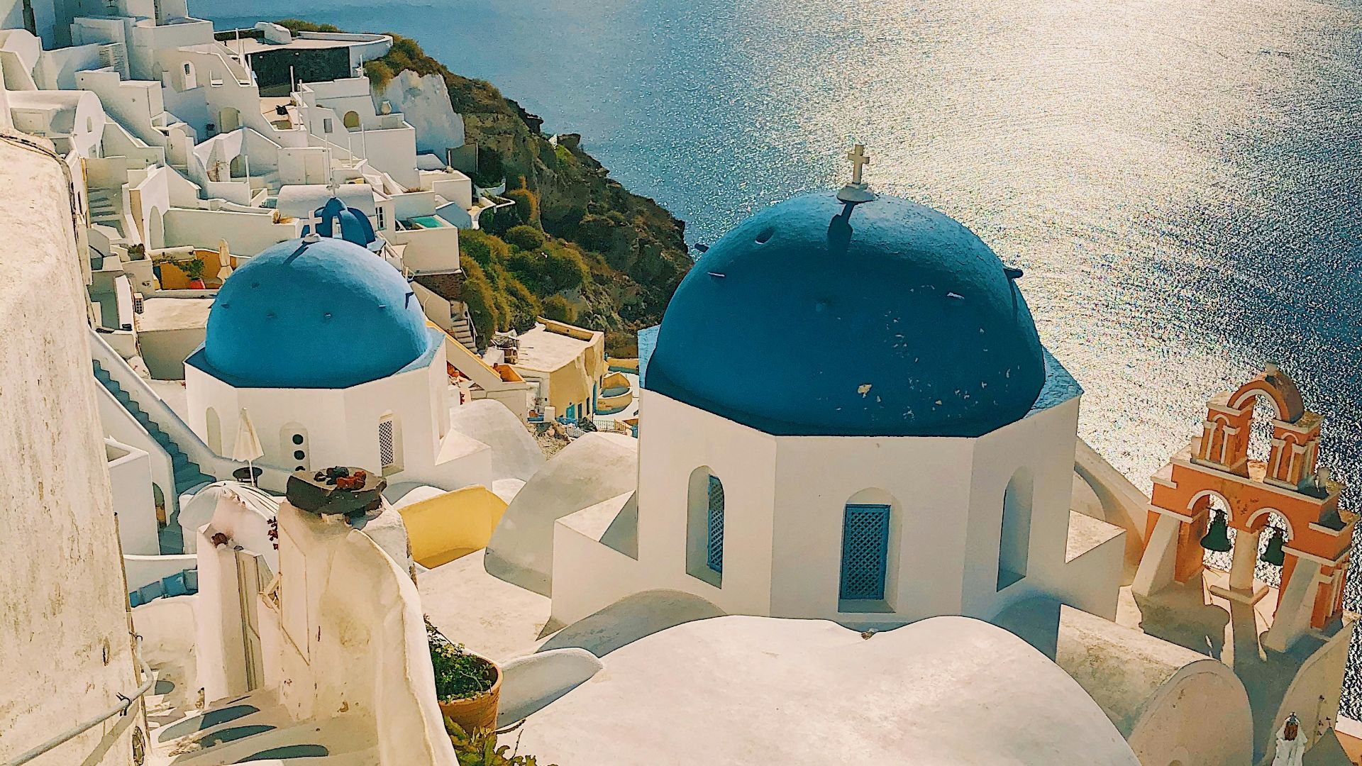 white and blue concrete building near body of water during daytime