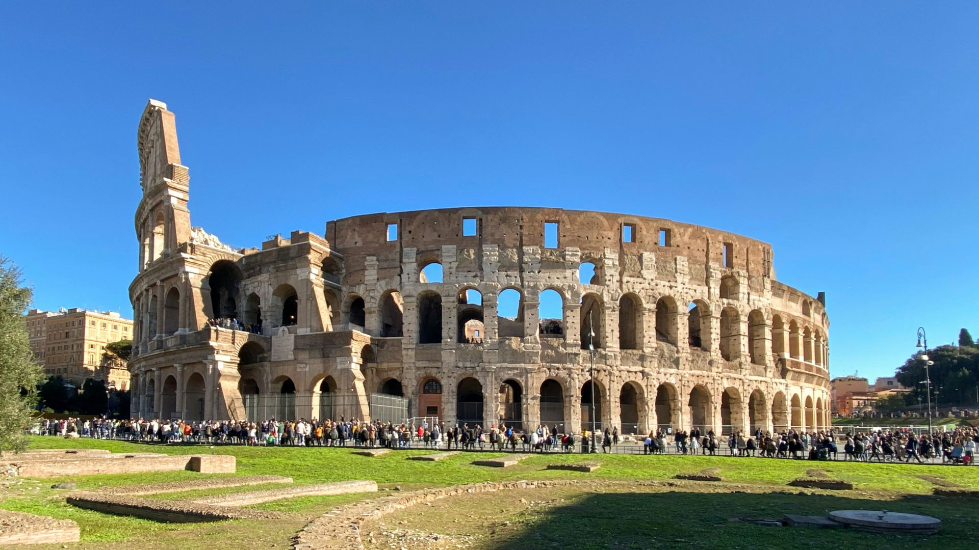 a group of people standing in front of an old building