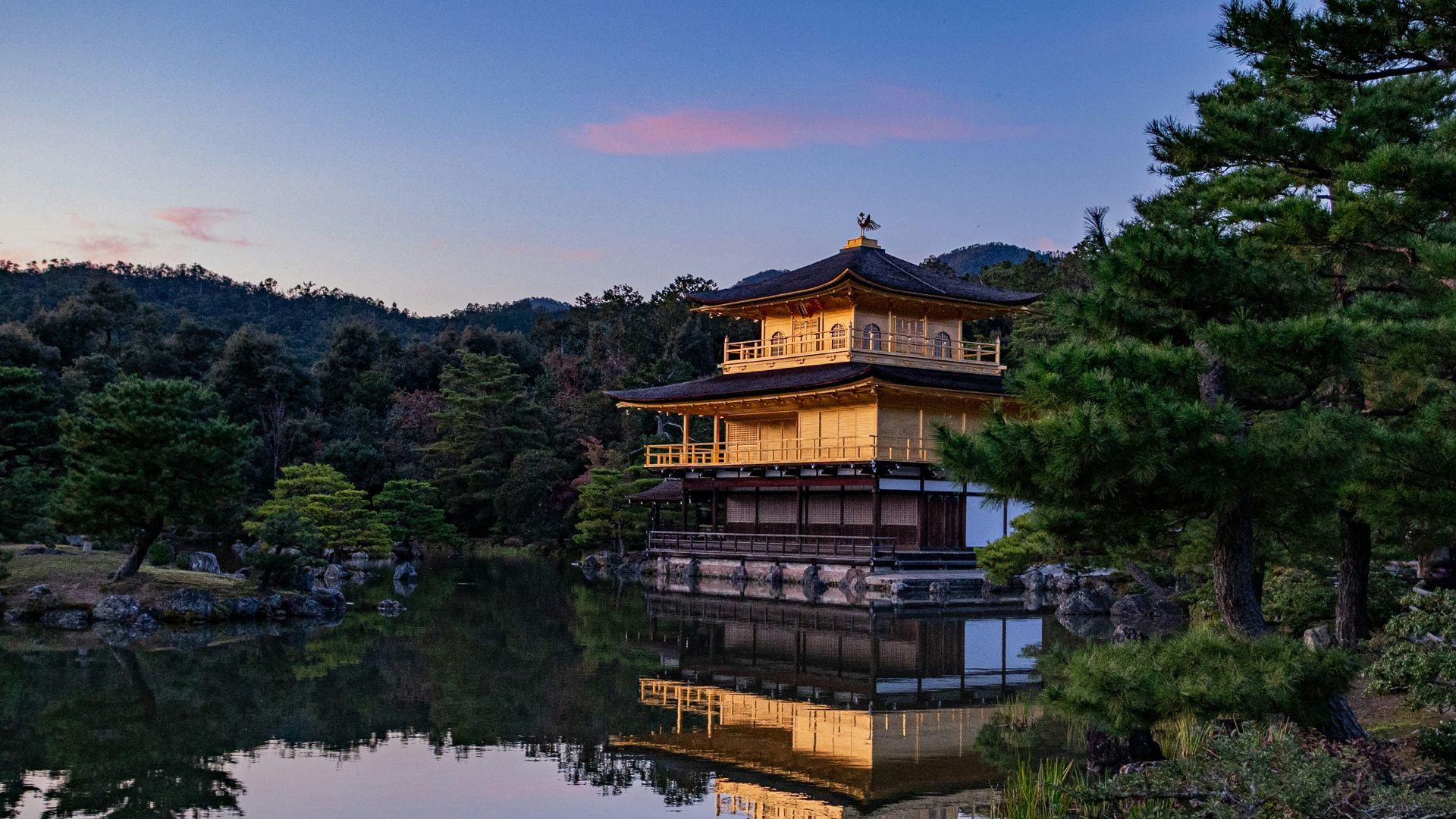 golden temple surrounded with body of water