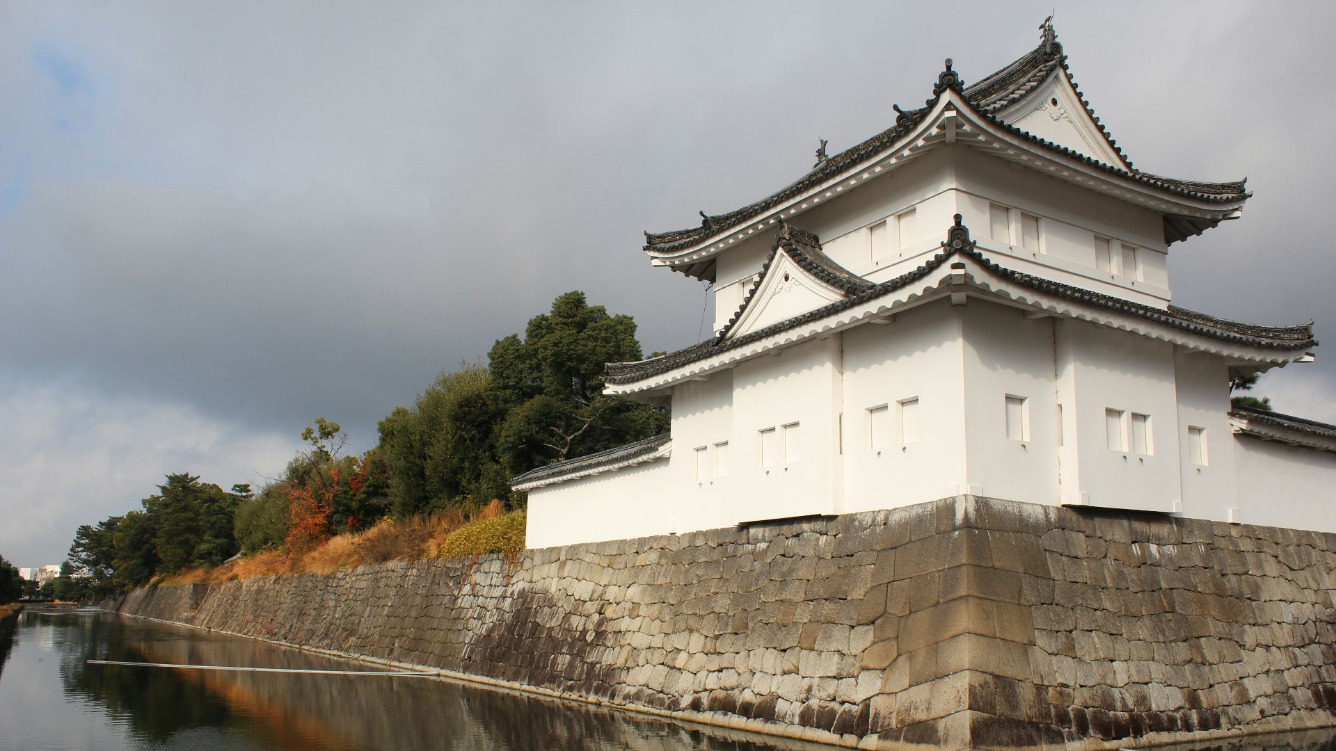 a white building sitting on the side of a river